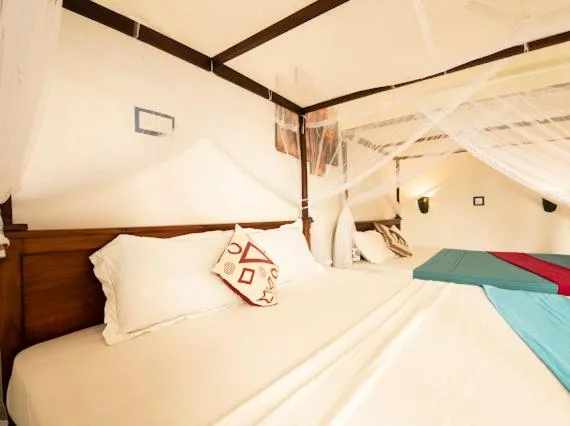 Bed in Frangipani Beach Villa