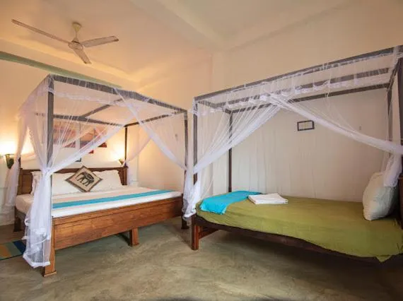 Bed in Frangipani Beach Villa