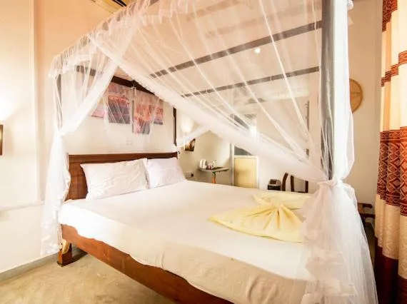 Bed in Frangipani Beach Villa