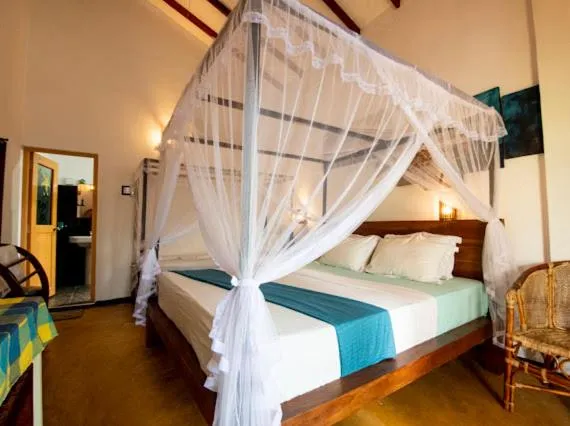 Bed in Frangipani Beach Villa