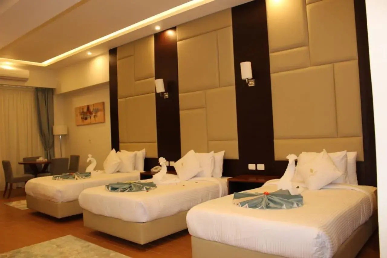 Triple Room with Side Sea View and Garden View in Royal Jewel Al Raml Hotel Triple Room with Side Sea View and Garden View in Royal Jewel Al Raml Hotel