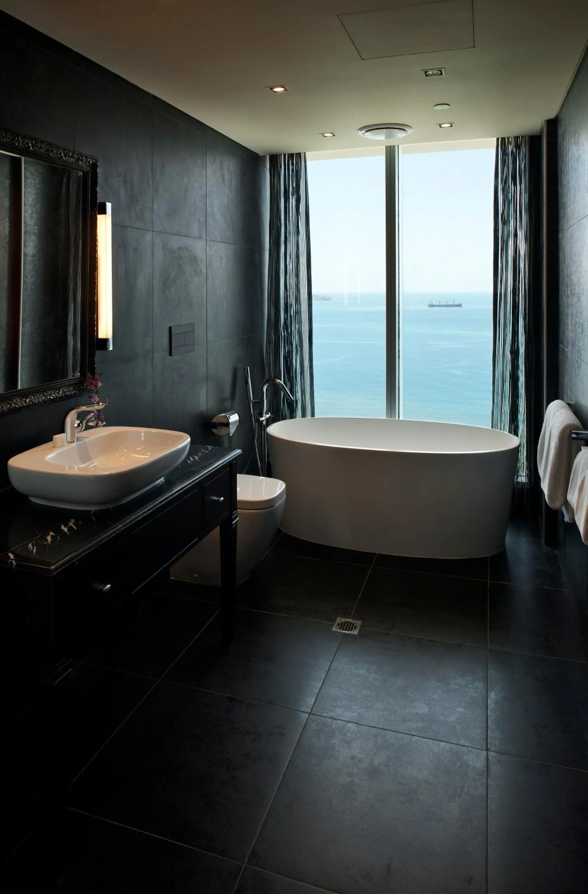 Bath, Bed in Grand Papua Hotel