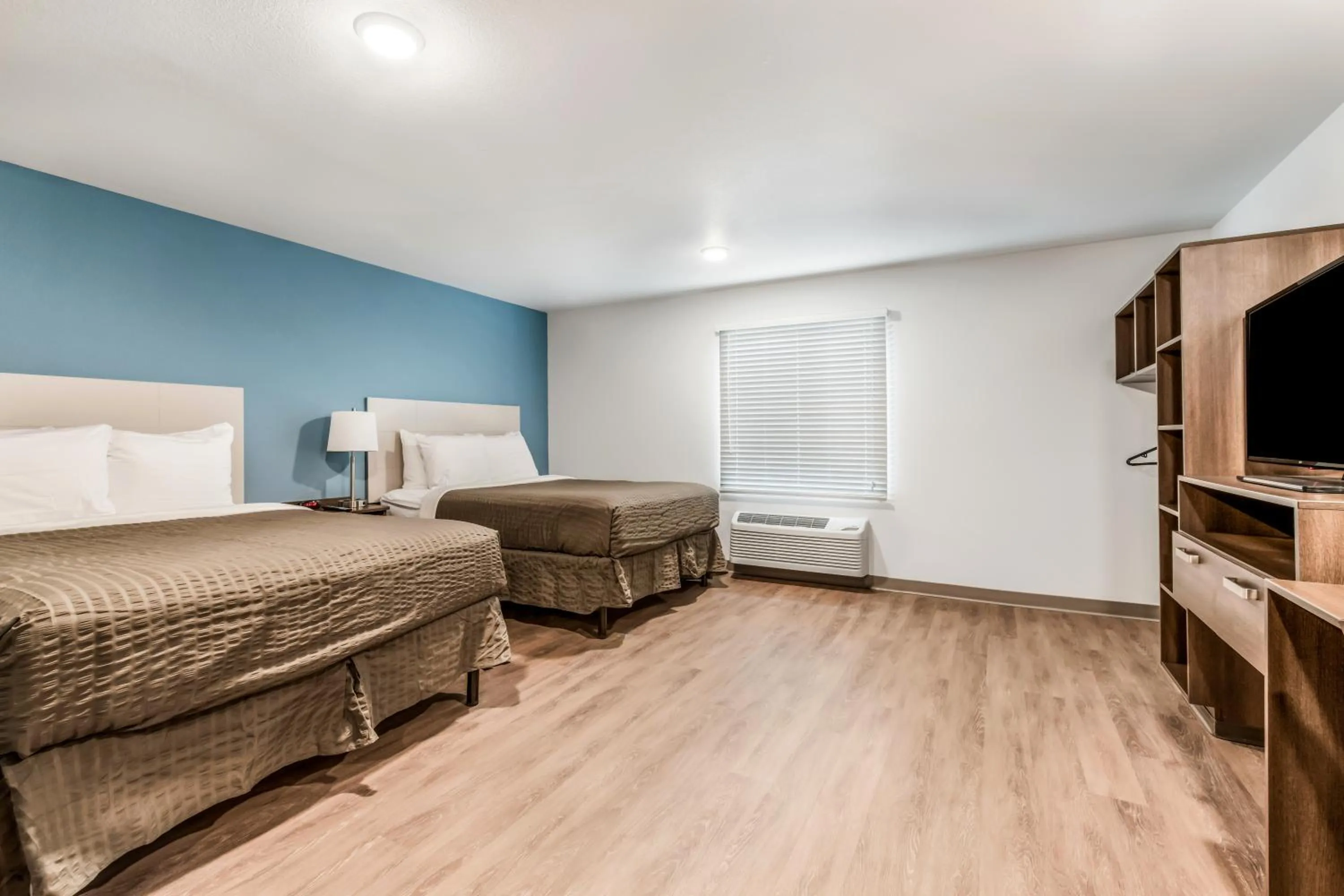 Bed in WoodSpring Suites Charlotte - University Research Park