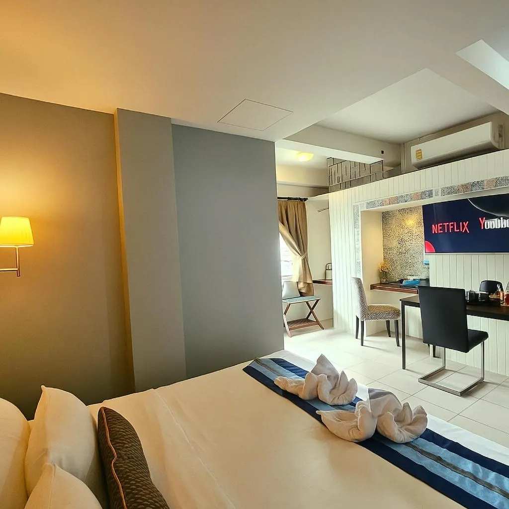 Bed in Montree Phuket Hotel