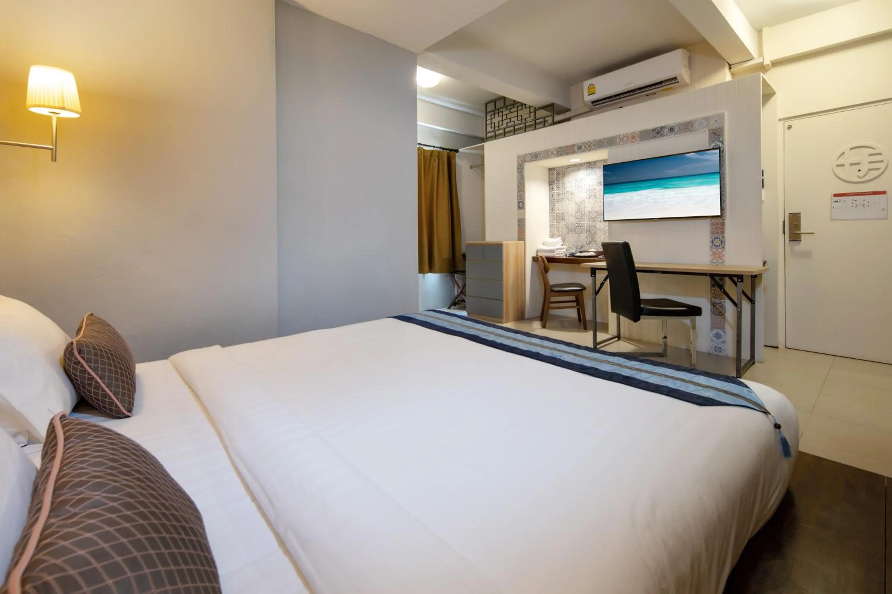 Bed in Montree Phuket Hotel