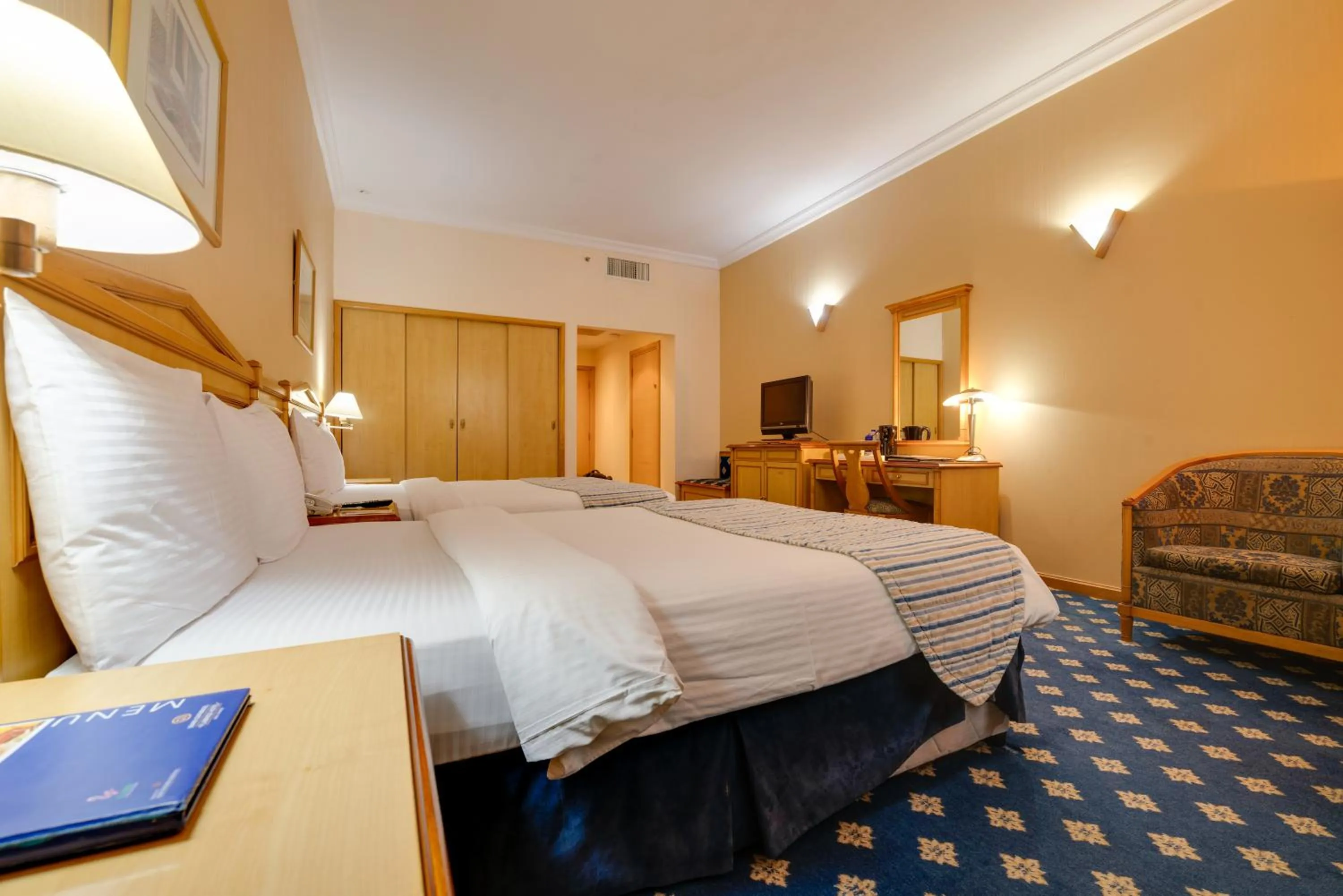 Bed in Grand Continental Hotel