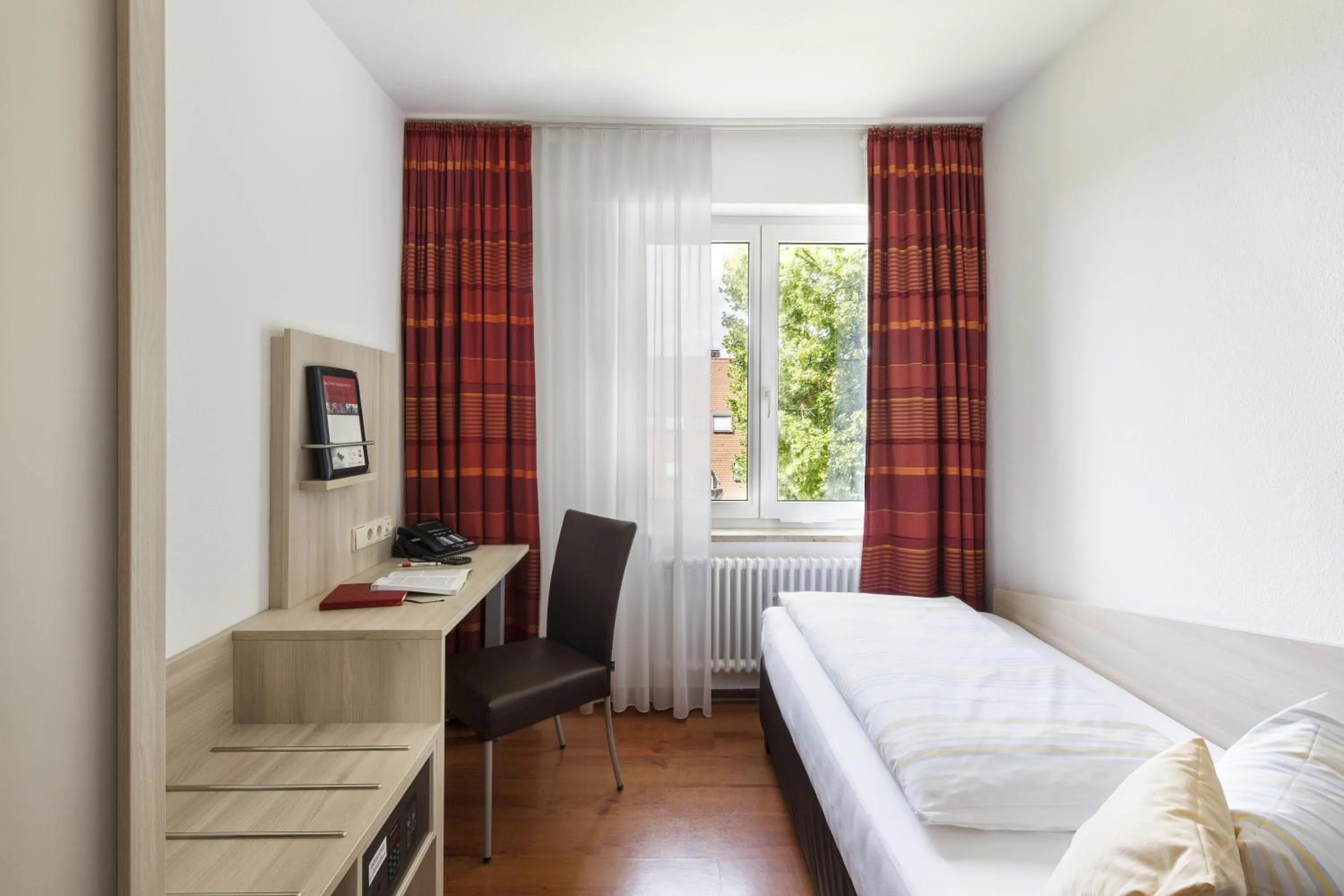 Photo of the whole room, Bed in Caritas Tagungszentrum