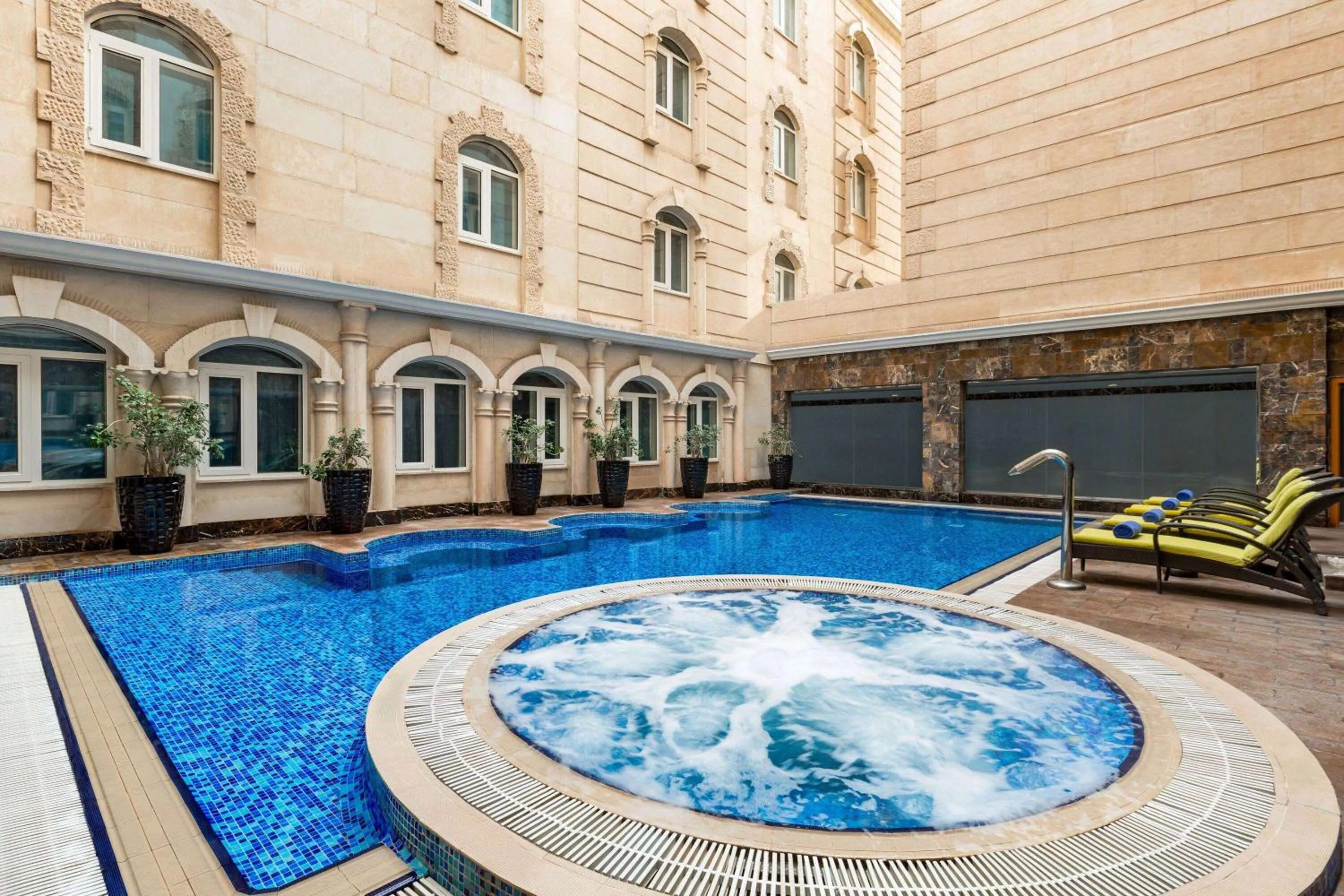 Swimming pool in Grand Regency Doha, Trademark Collection by Wyndham