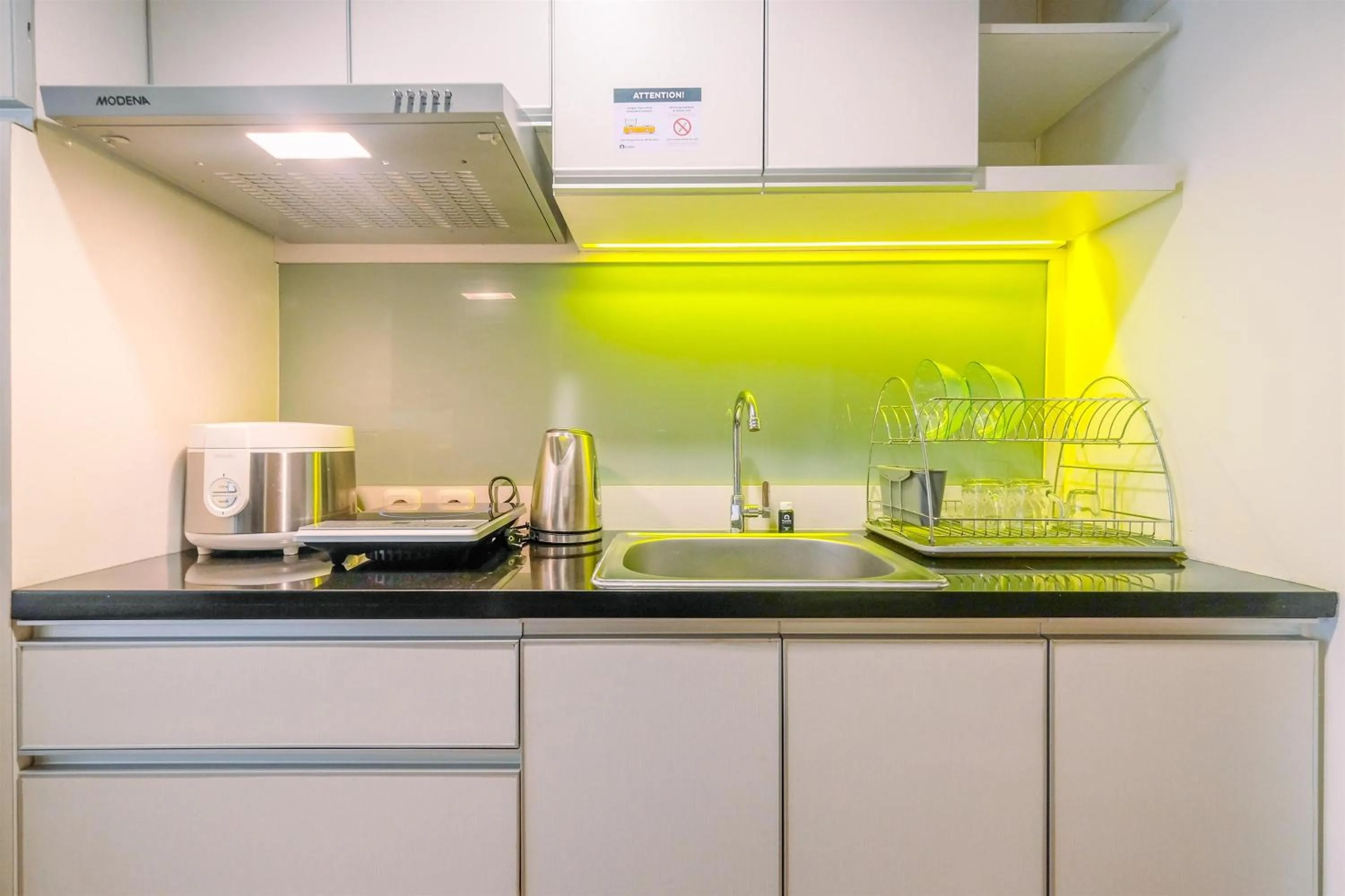 Kitchen or kitchenette in Minimalist Studio at 11st Floor Bogor Icon Apartment By Travelio