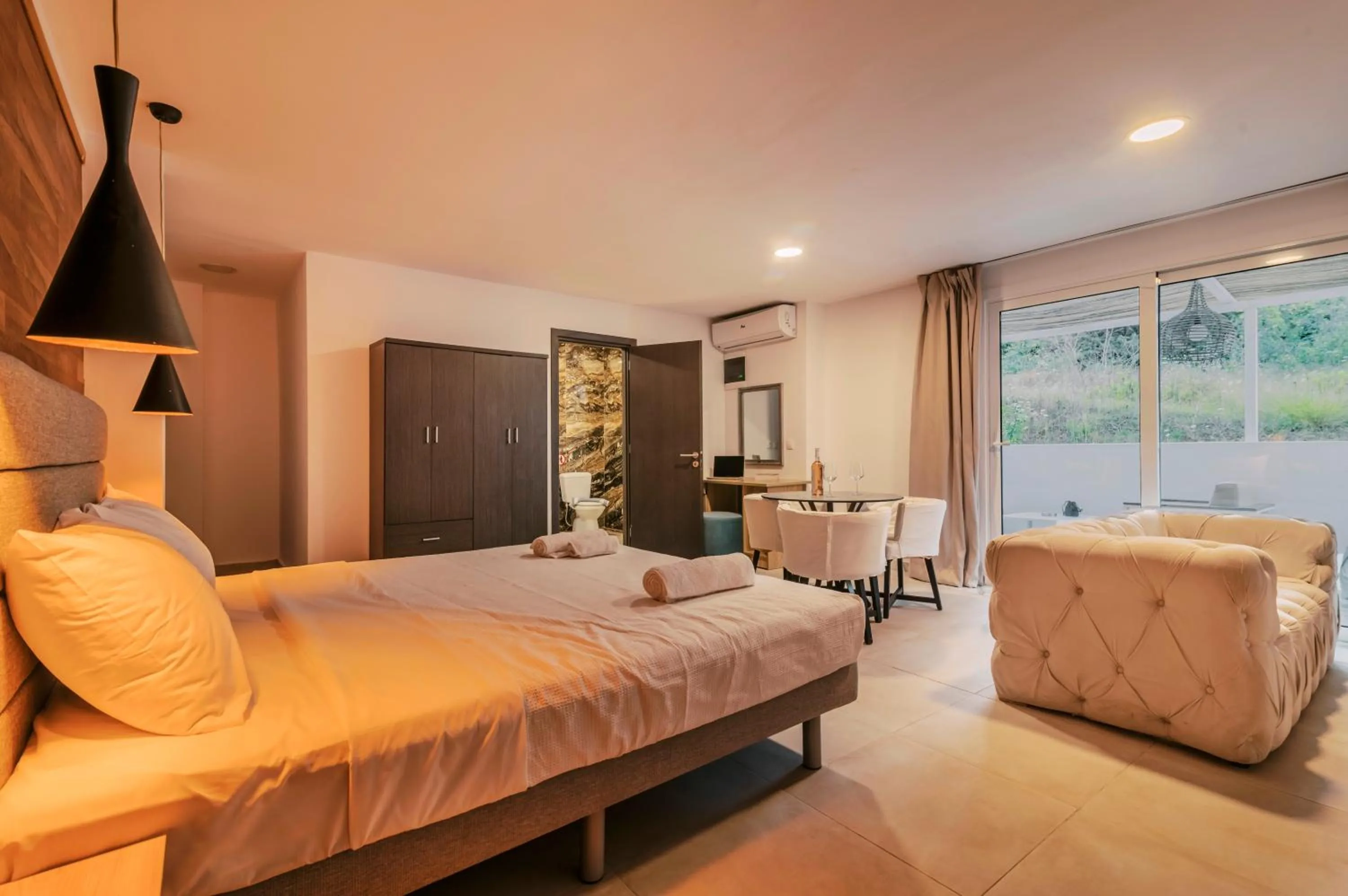Photo of the whole room, Bed in Bamboo Suites Hotel - Adults Only