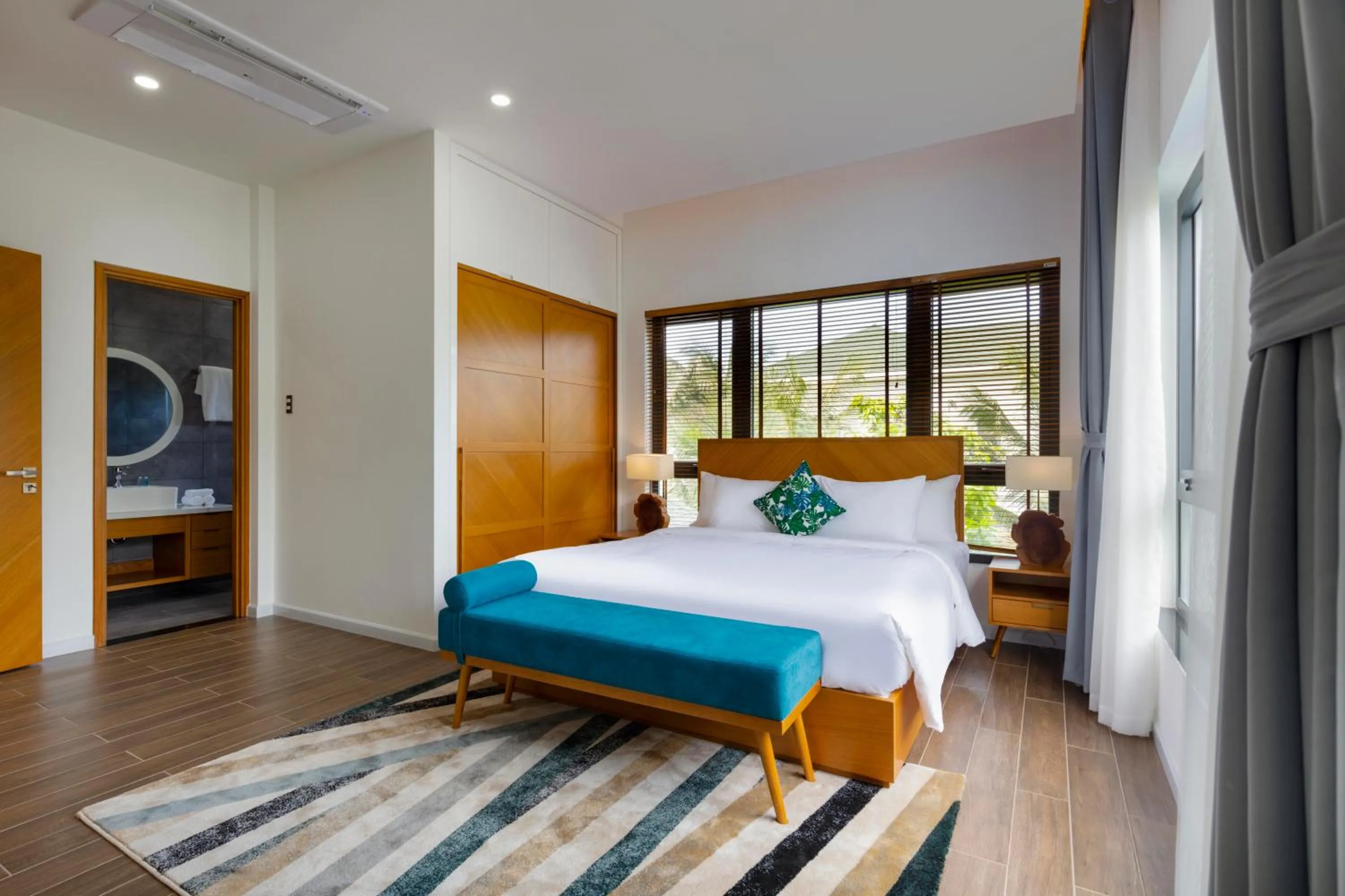 Bedroom, Bed in Le Palmier Ho Tram Resort - Beachfront with Private Beach