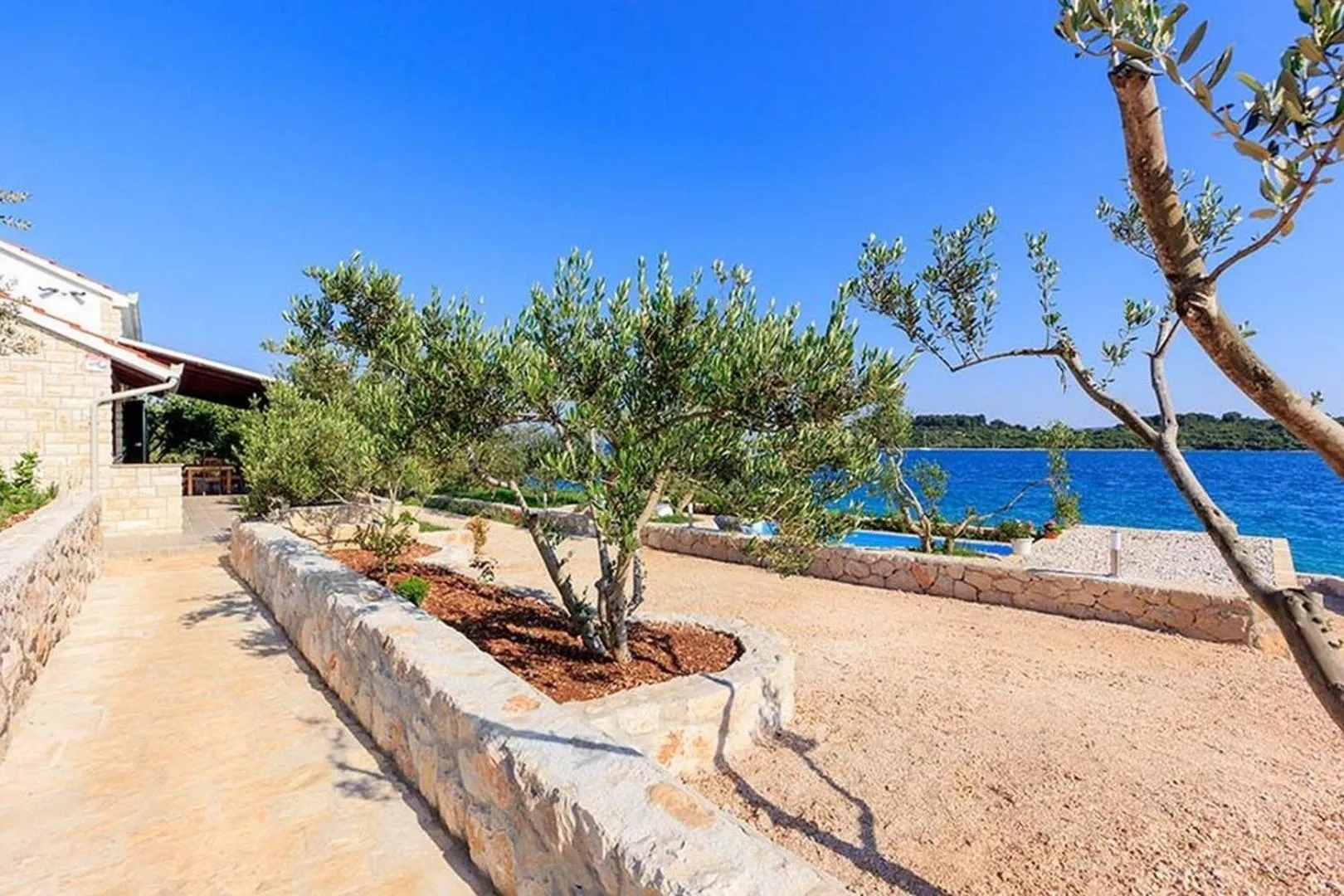 Property building in Luxury Beachfront Villa Dalmatino Trogir with private pool right at the beach in Okrug Gornji - Ciovo