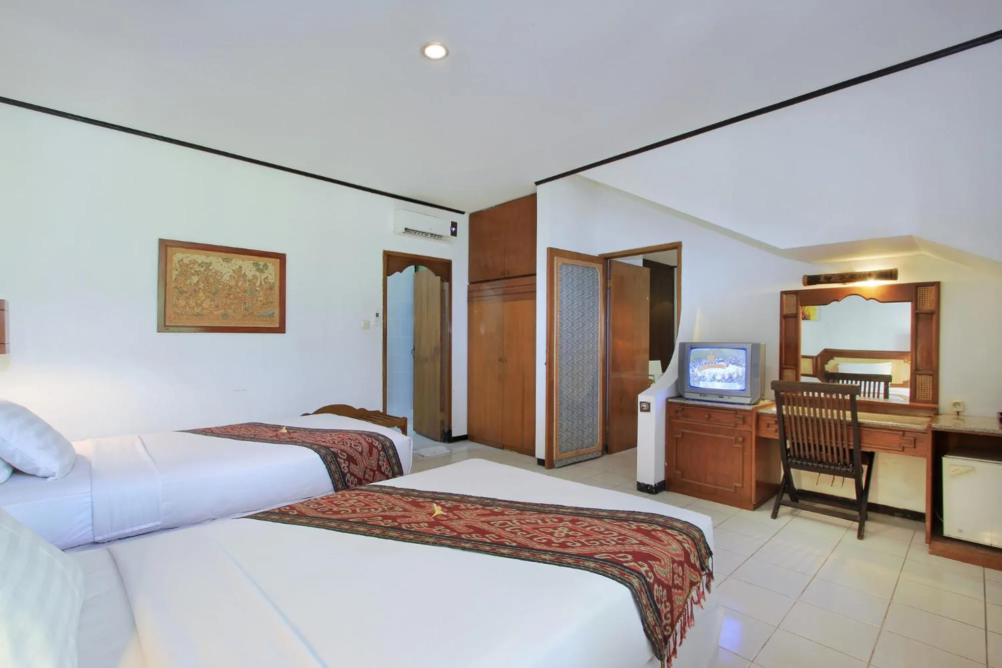 Bed in Puri Naga Beachfront Cottages