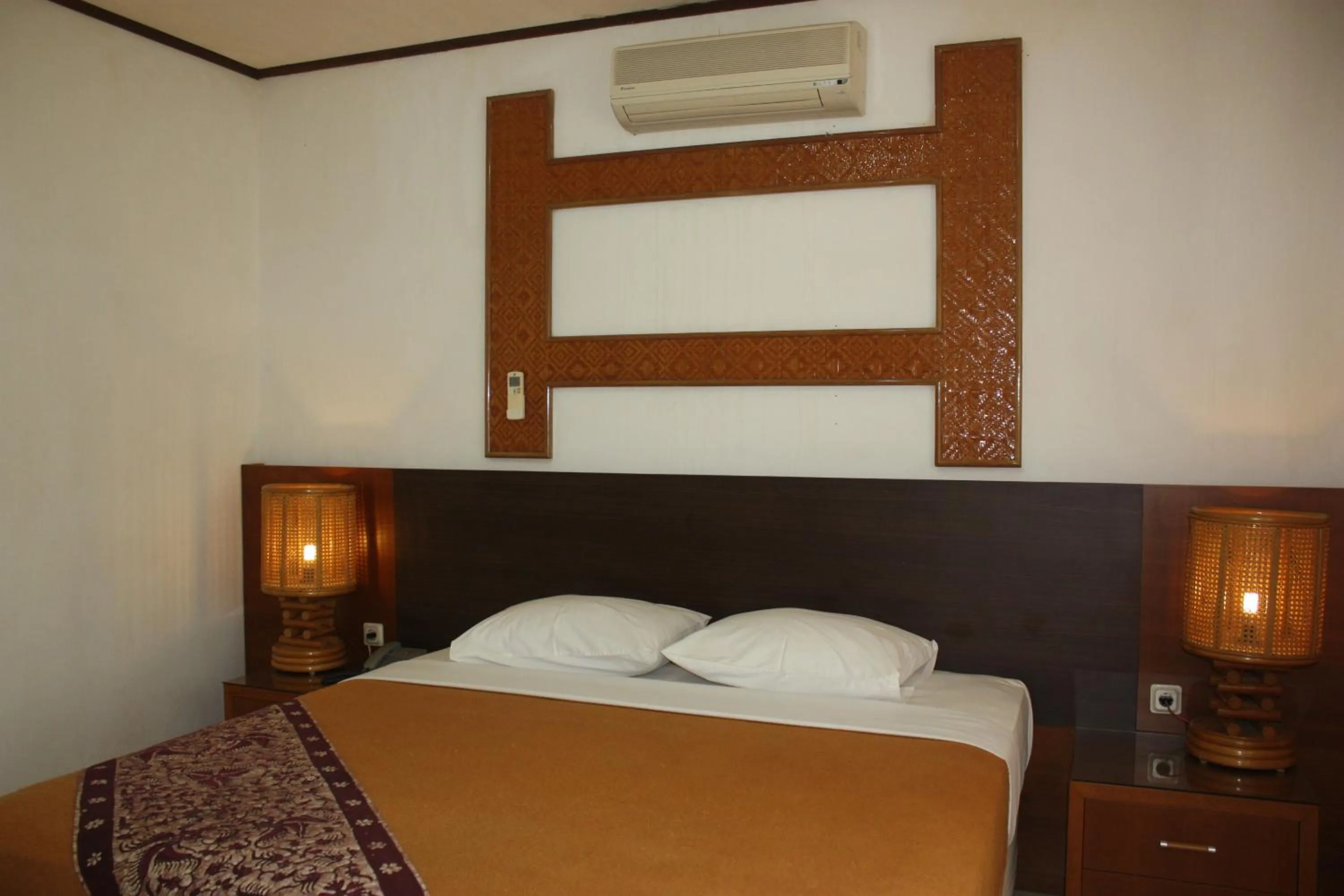 Bed in Puri Naga Beachfront Cottages
