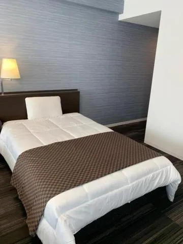 Bed in Sakura Hotel Onomichi Ekimae