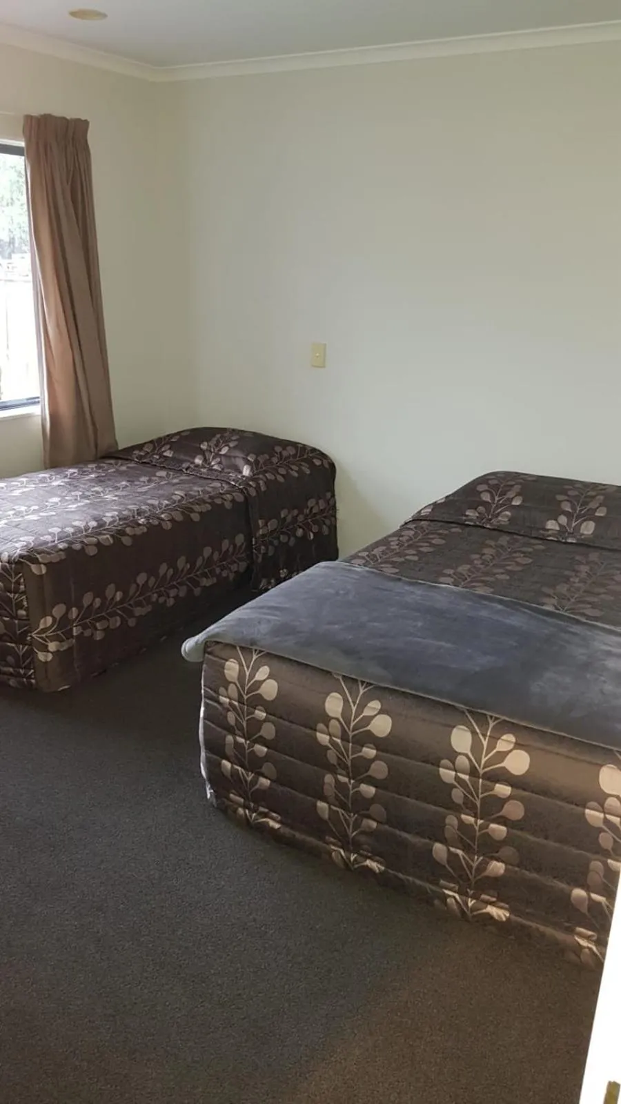 Bed in Tudor Lodge Motel
