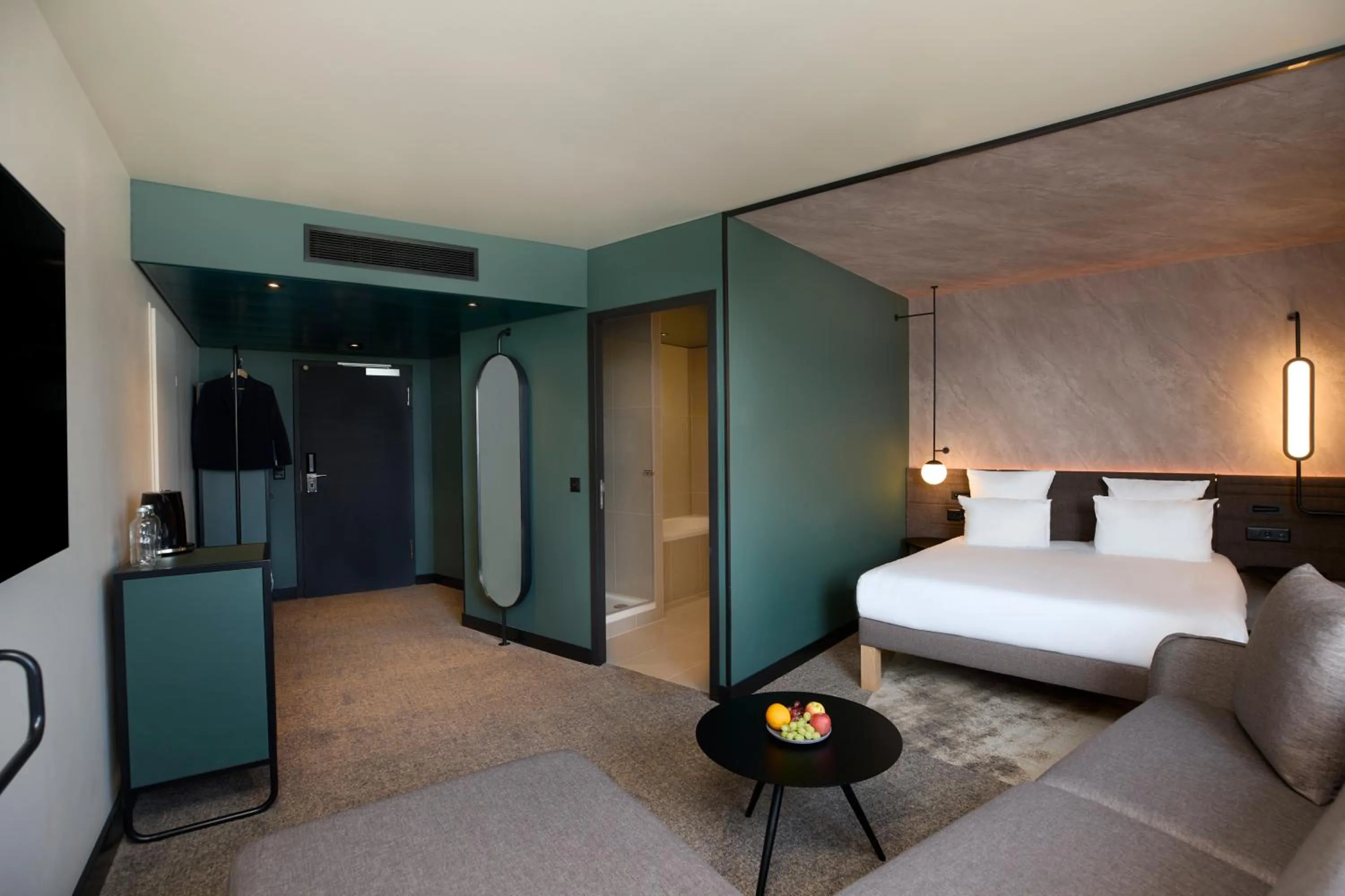 Living room, Bed in Novotel Bern Expo