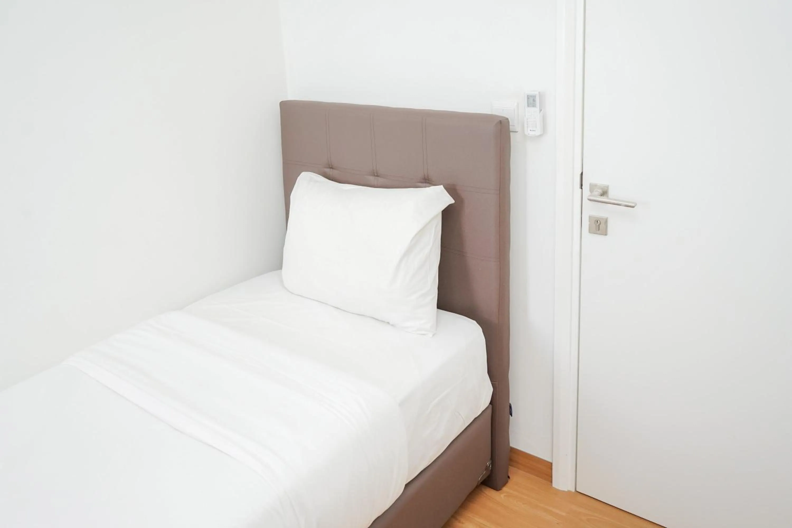 Bed in Cozy 2BR Apartment at Tuscany Residences With Garden View By Travelio