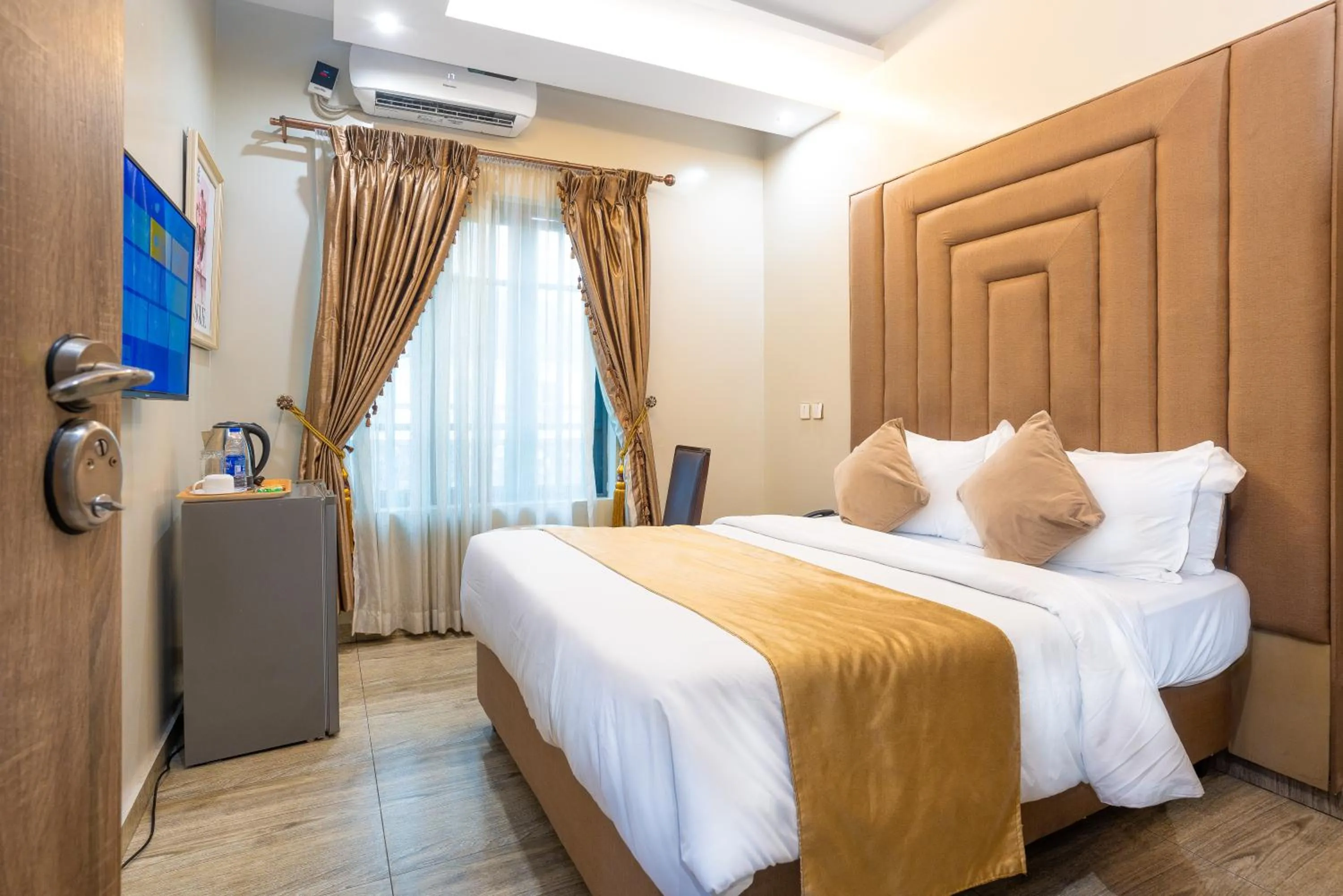 Bed in God's Touch Apartments Signature