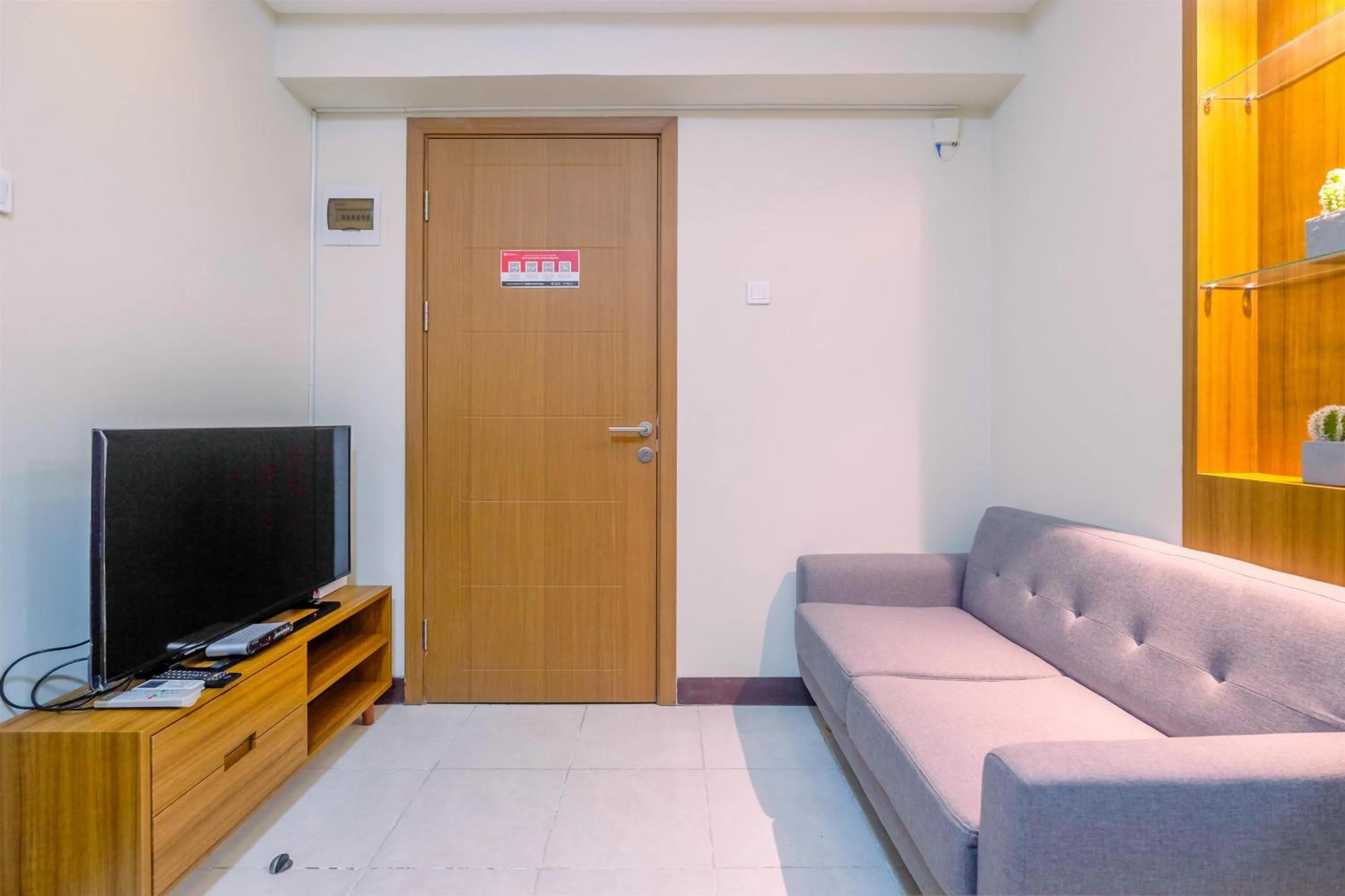 Living room in Comfortable 2BR Apartment at Cinere Resort By Travelio