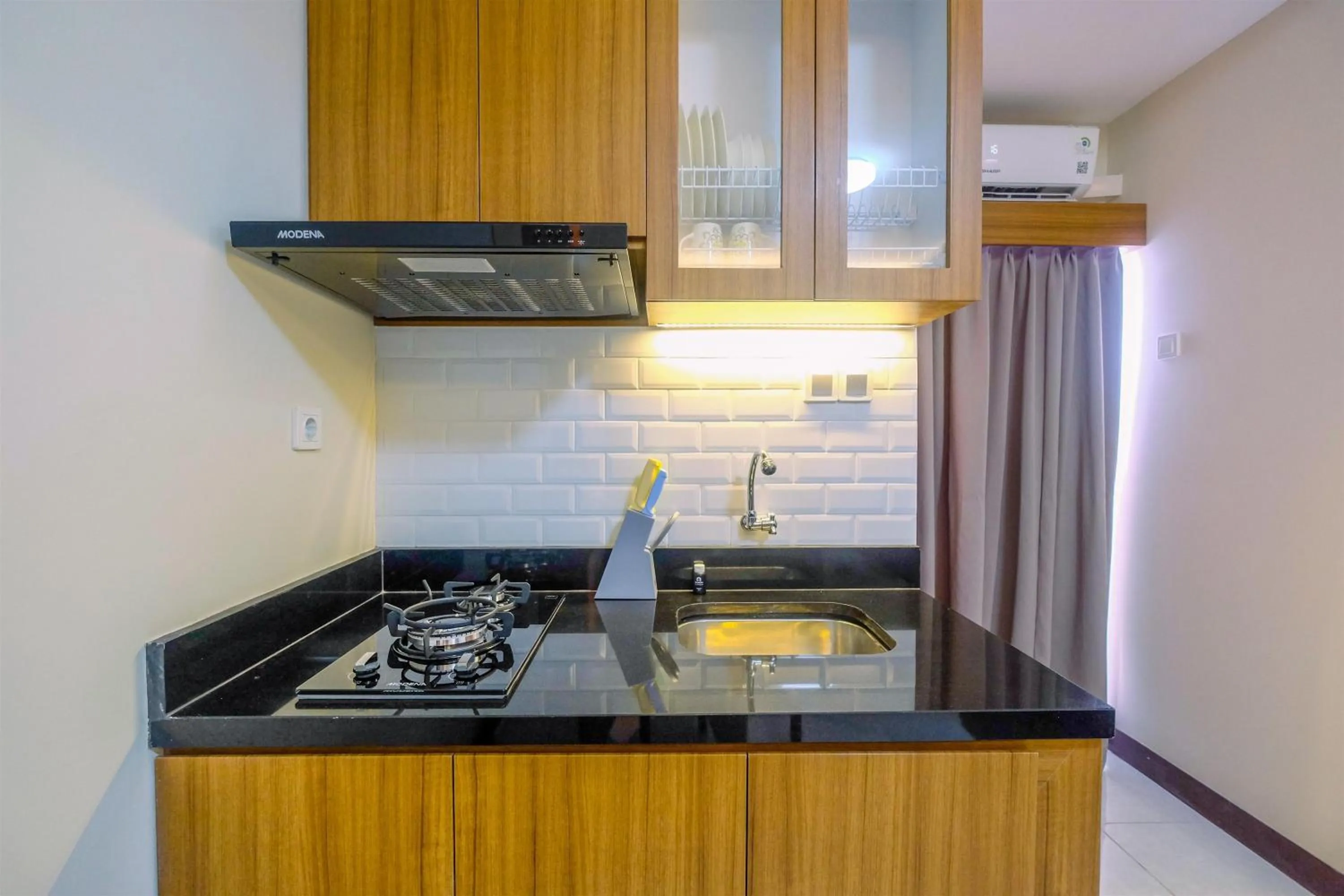 Kitchen or kitchenette in Comfortable 2BR Apartment at Cinere Resort By Travelio