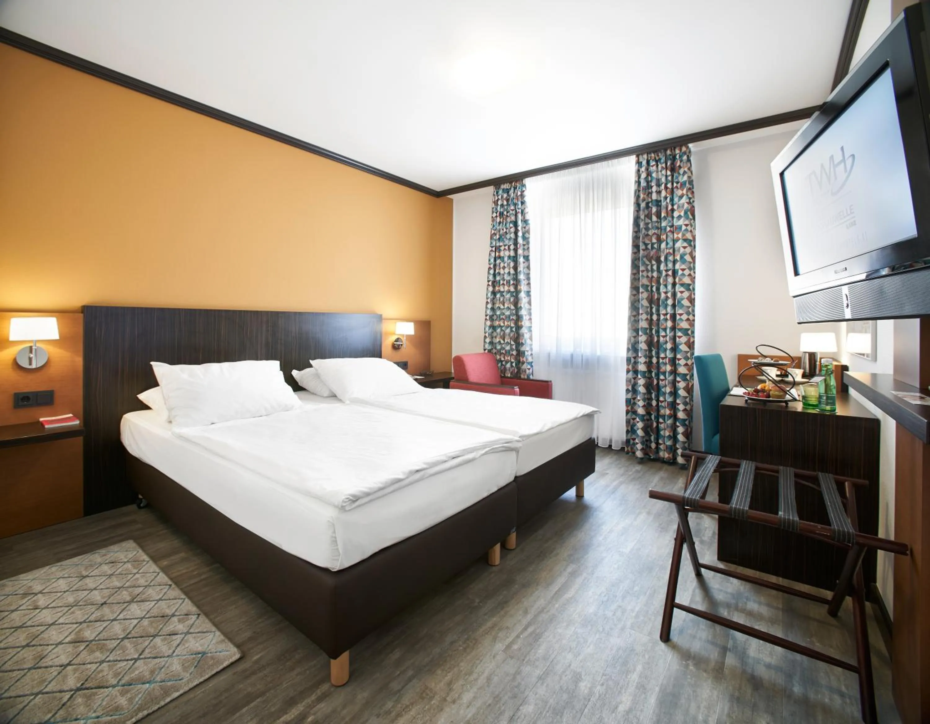 Comfort double room with twin beds and connecting door in Trans World Hotel Donauwelle