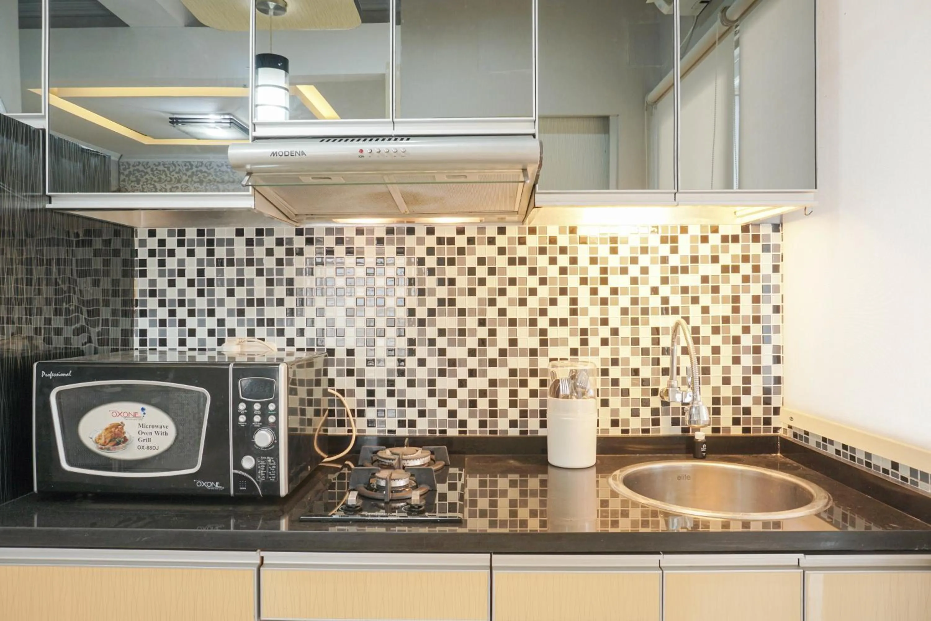 Kitchen or kitchenette in Beautiful and Comfy 2BR Menteng Square Apartment By Travelio