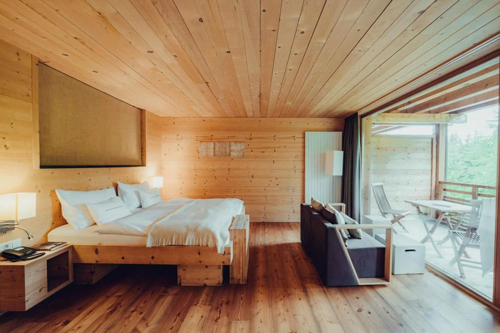 Bed in Holzhotel Forsthofalm