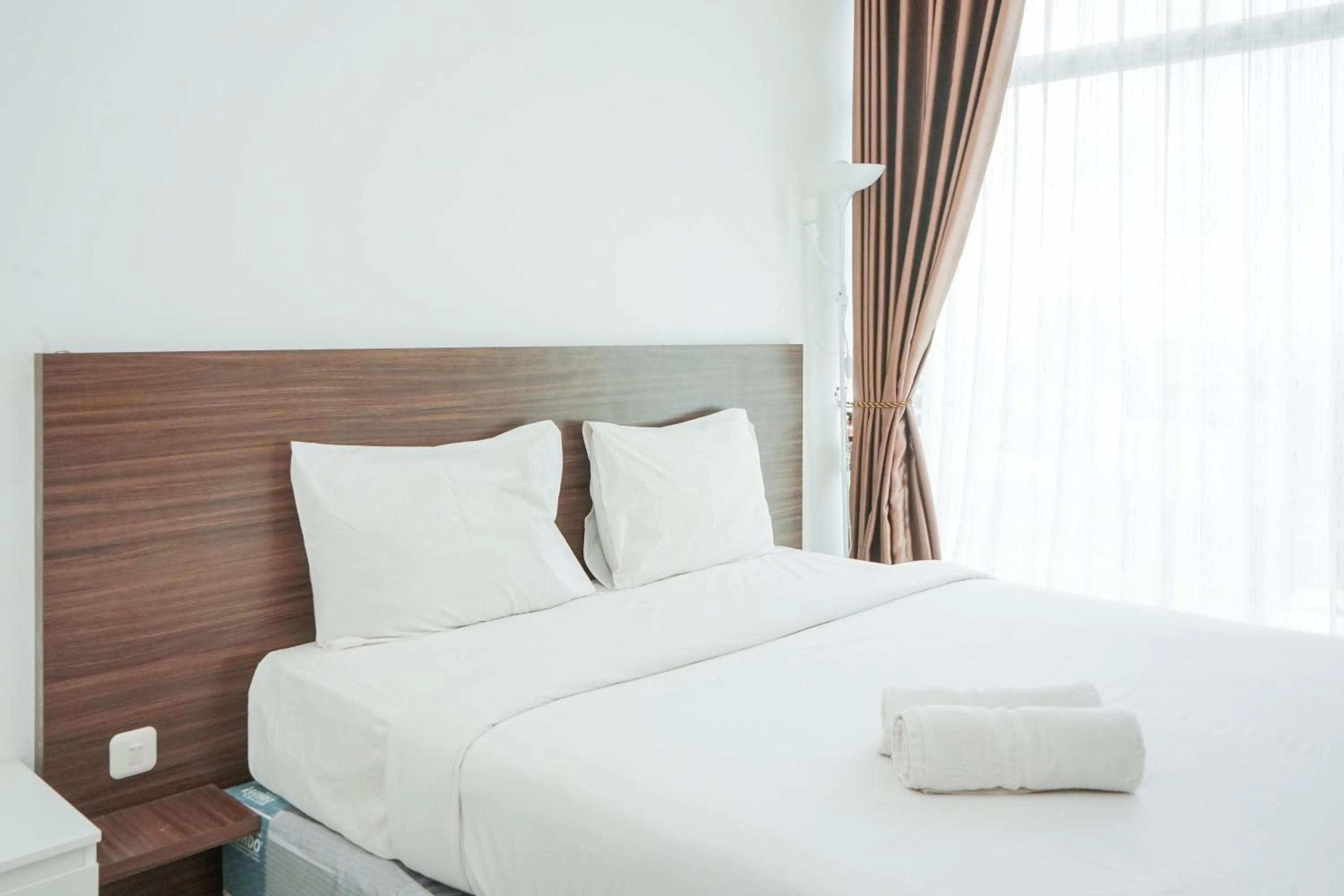 Bed in Modern Studio Apartment at Tree Park Cikokol By Travelio