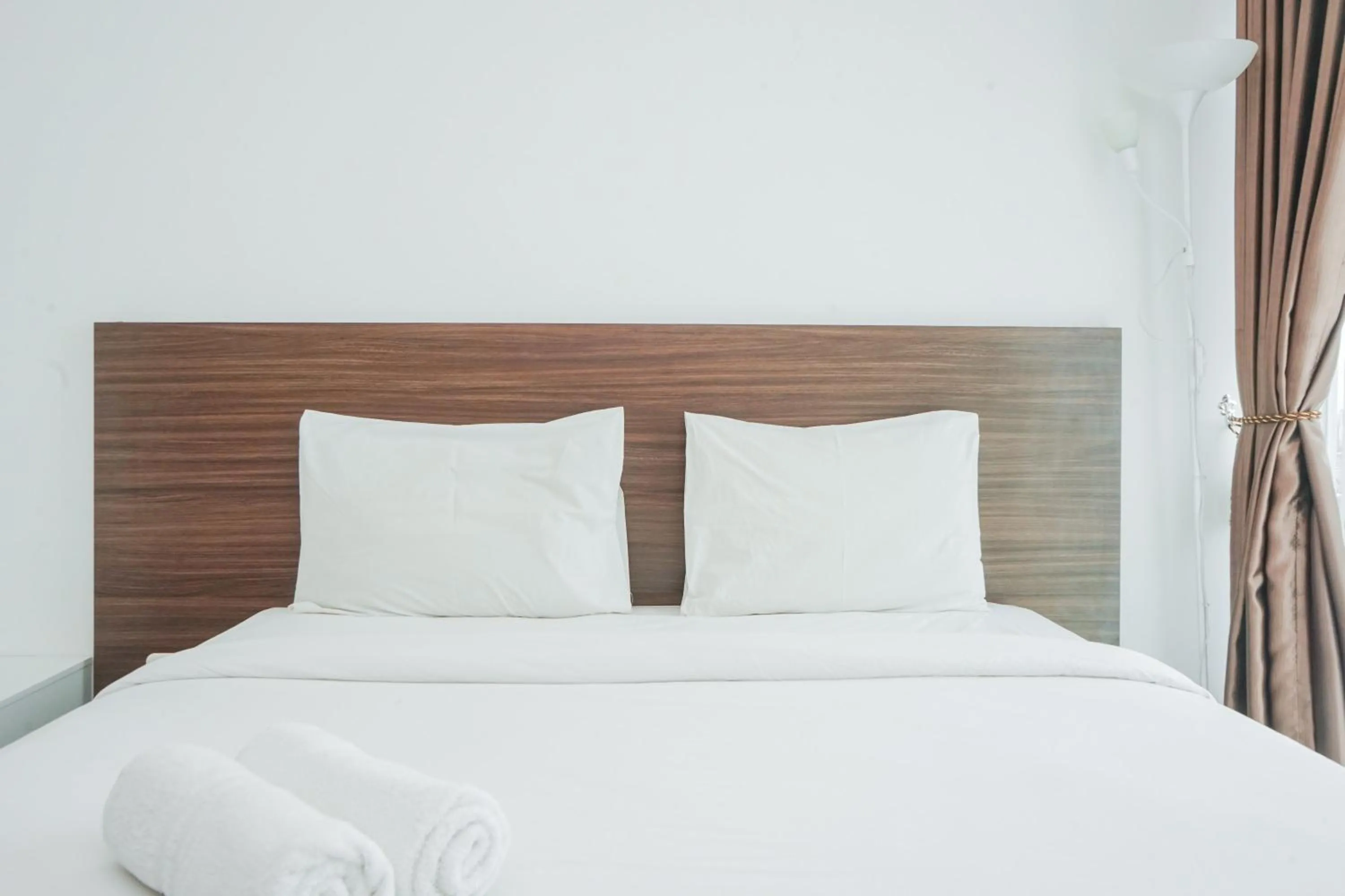 Bed in Modern Studio Apartment at Tree Park Cikokol By Travelio