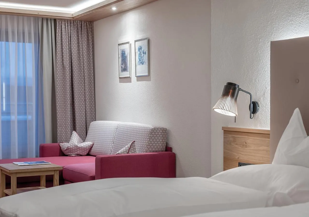 Seating area, Bed in Hotel Alpenland