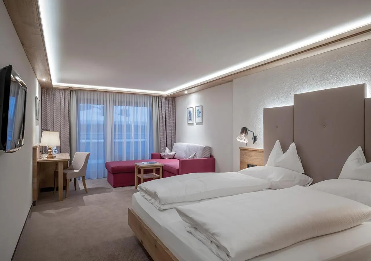 Seating area, Bed in Hotel Alpenland