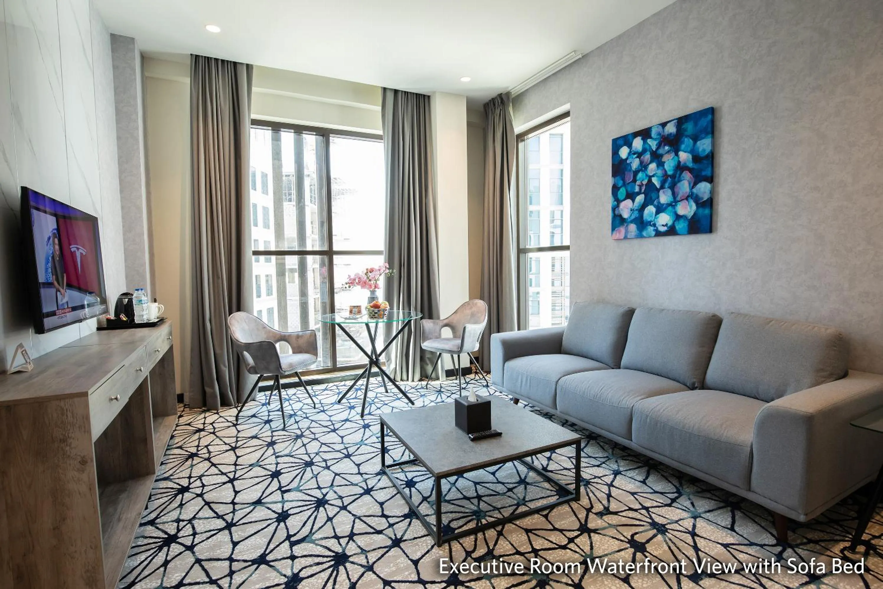 Communal lounge/ TV room in Grand Kingsgate Jaddaf Waterfront Hotel by Millennium