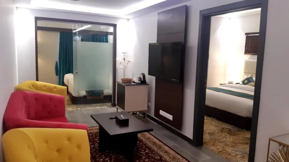 Communal lounge/ TV room, Bed in Faletti's Grand Hotel Multan