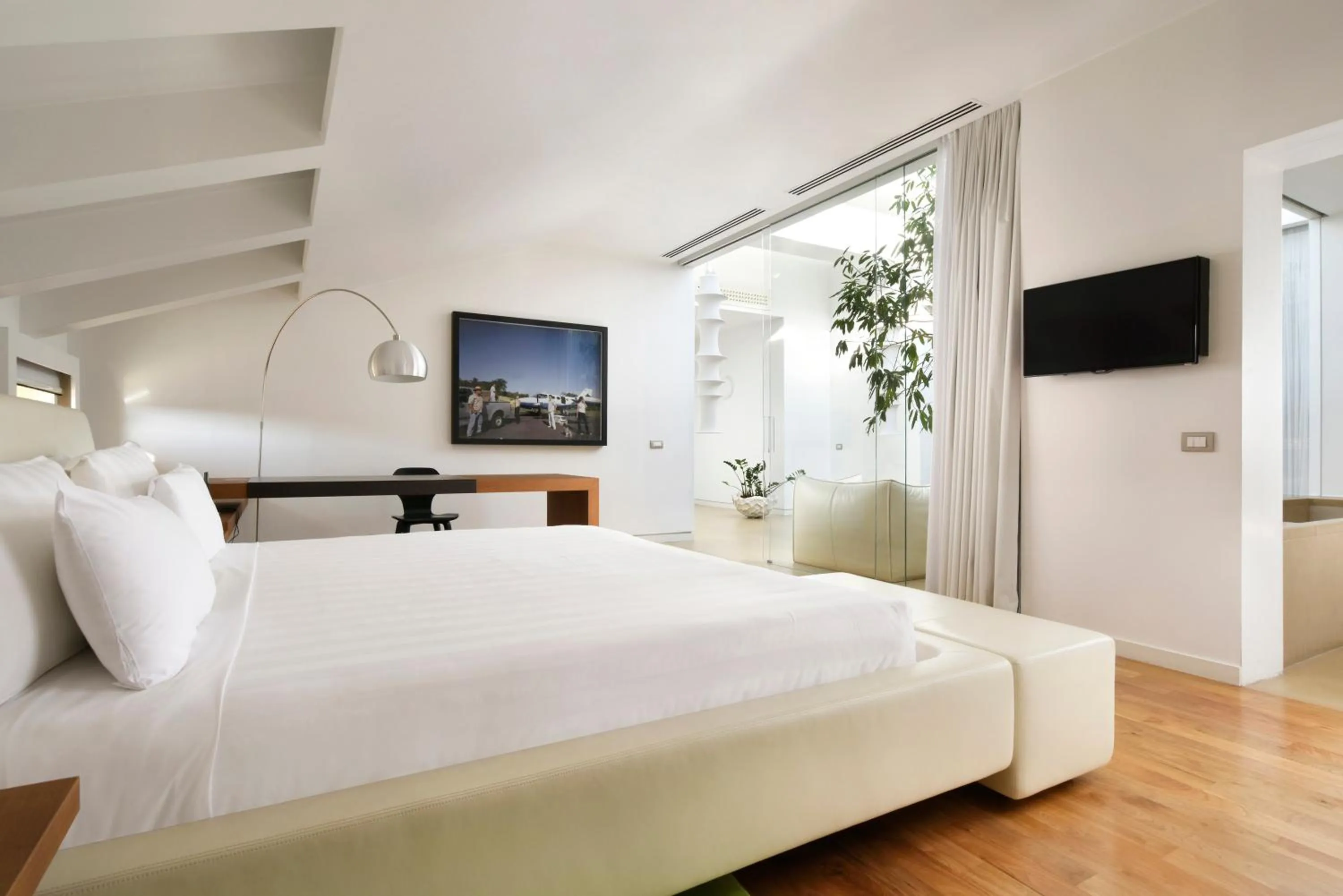 Bed in Palazzo Montemartini Rome, A Radisson Collection Hotel