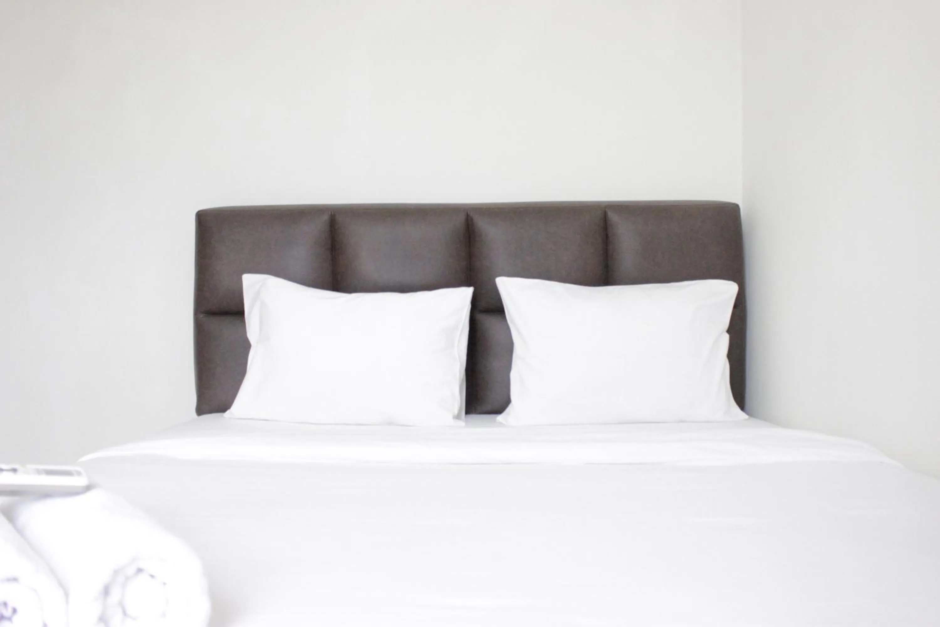 Bed in Homey 2BR Majesty Apartment near Maranatha University By Travelio