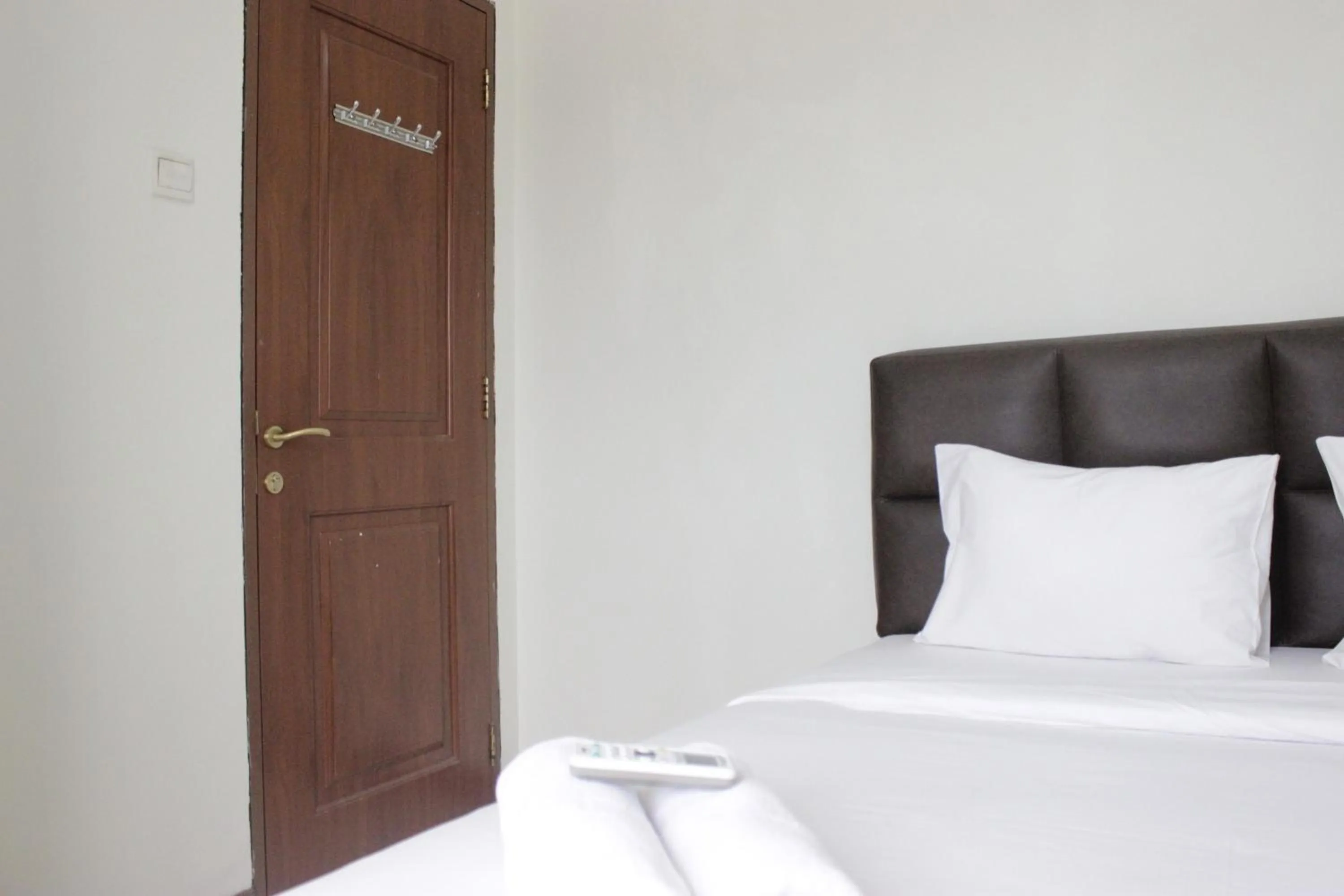 Bed in Homey 2BR Majesty Apartment near Maranatha University By Travelio