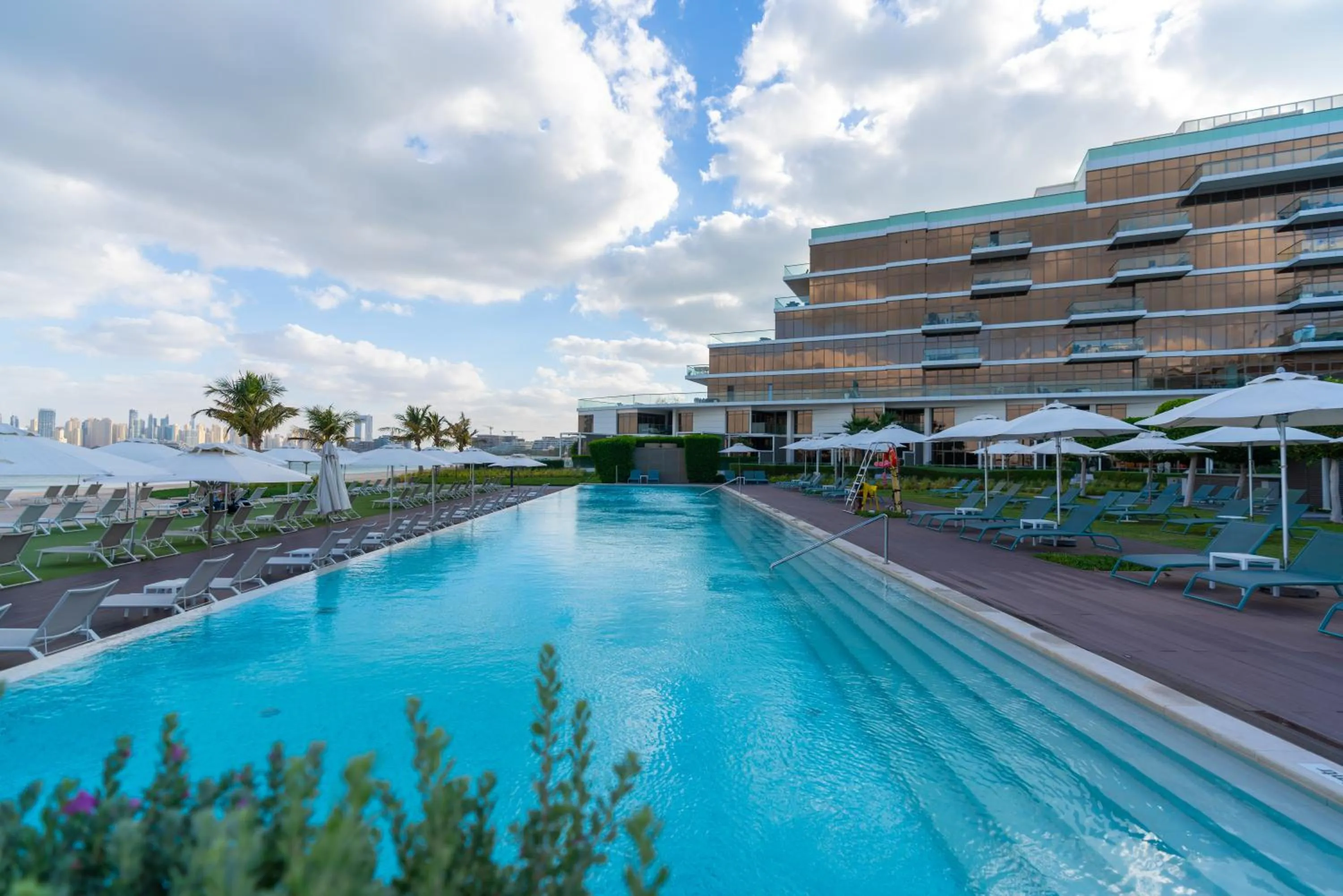 Swimming pool in Th8 Palm Dubai Beach Resort, Vignette Collection by IHG