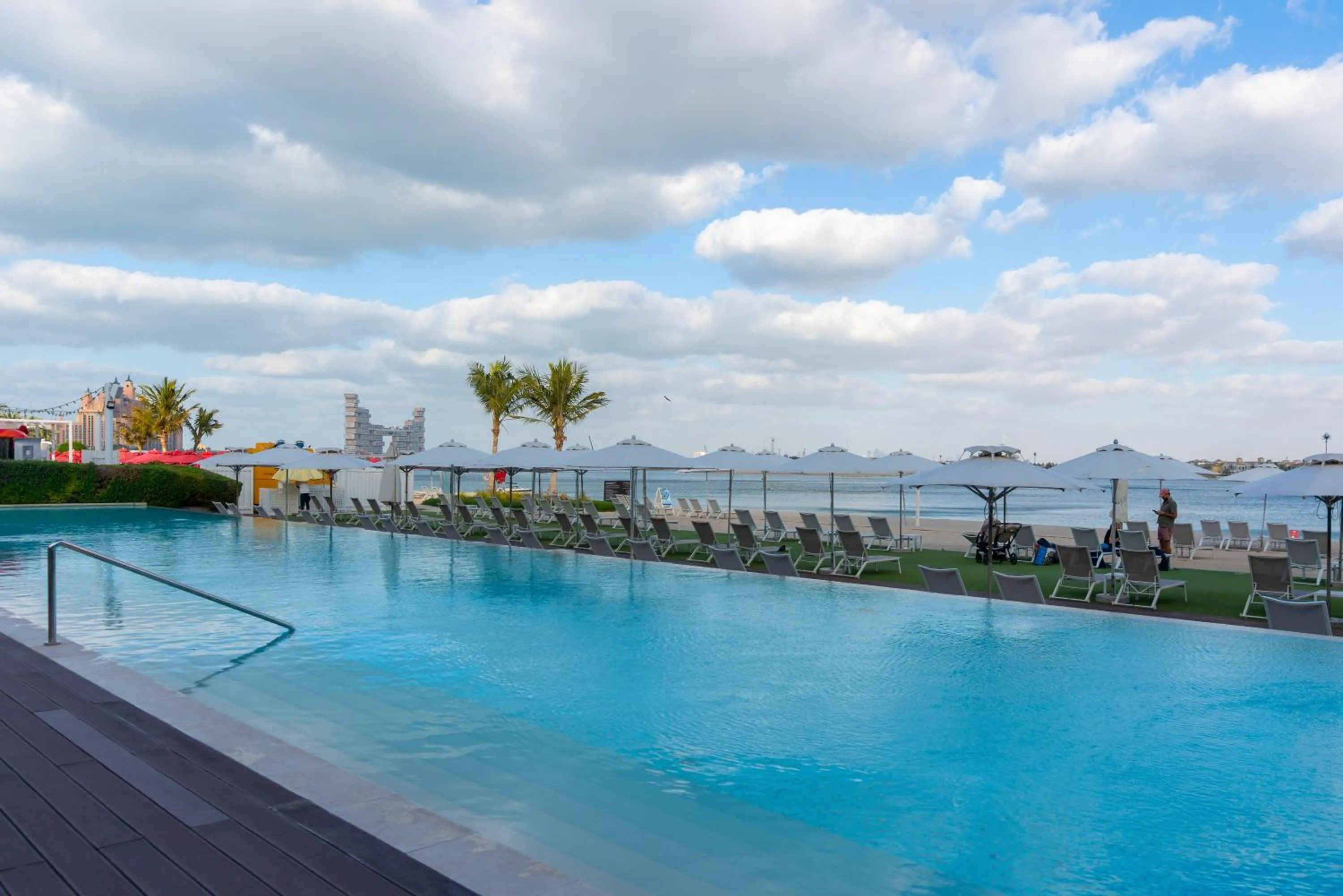 Swimming pool in Th8 Palm Dubai Beach Resort, Vignette Collection by IHG