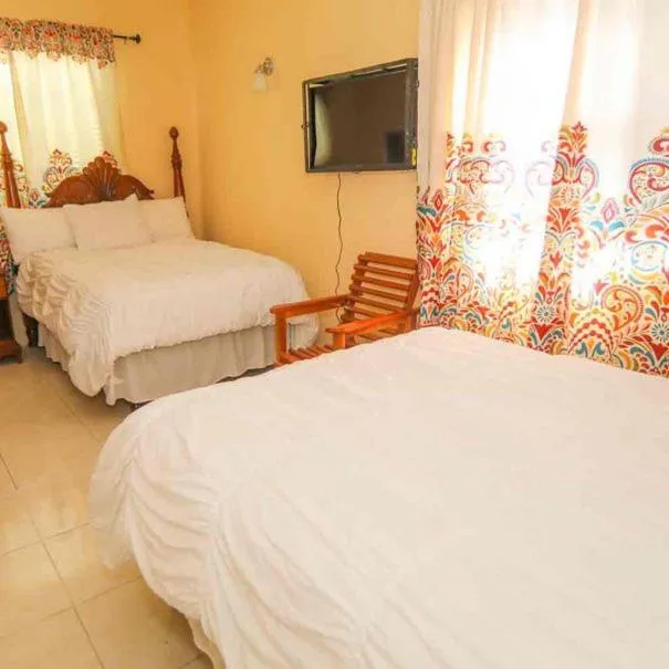 Bed in Dela de-Rose Guest House Negril Jamaica