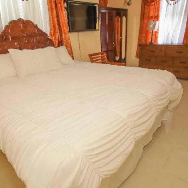 Bed in Dela de-Rose Guest House Negril Jamaica