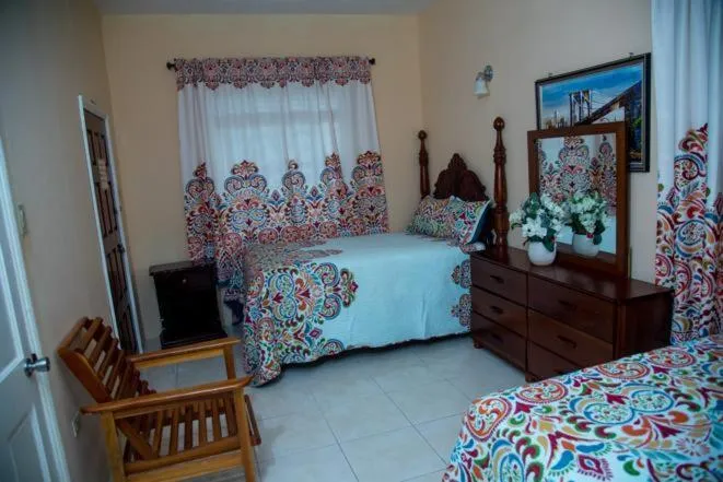 Bed in Dela de-Rose Guest House Negril Jamaica