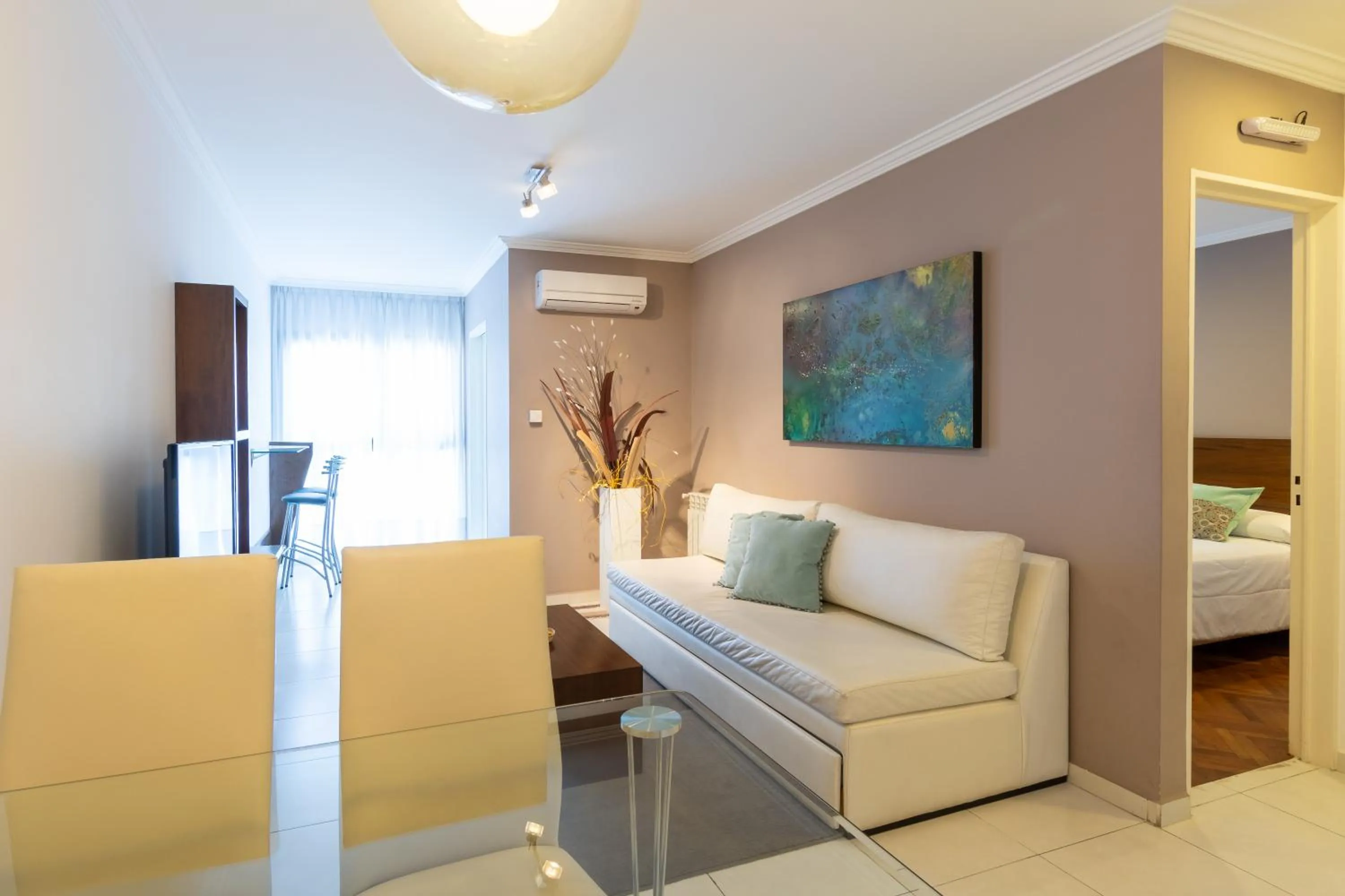 Living room, Bed in AT Suites