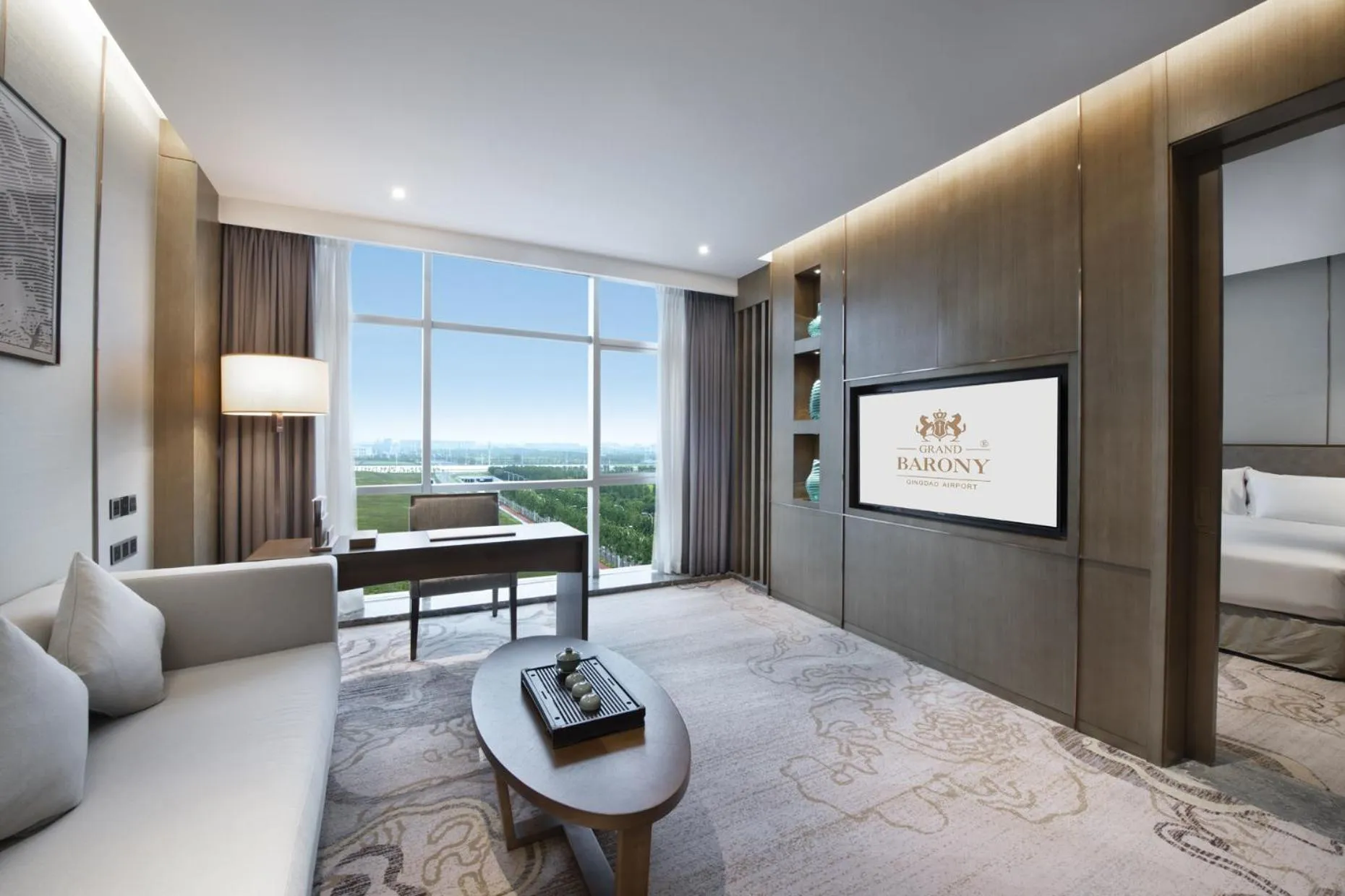 Living room, Bed in Grand Barony Qingdao Airport Hotel