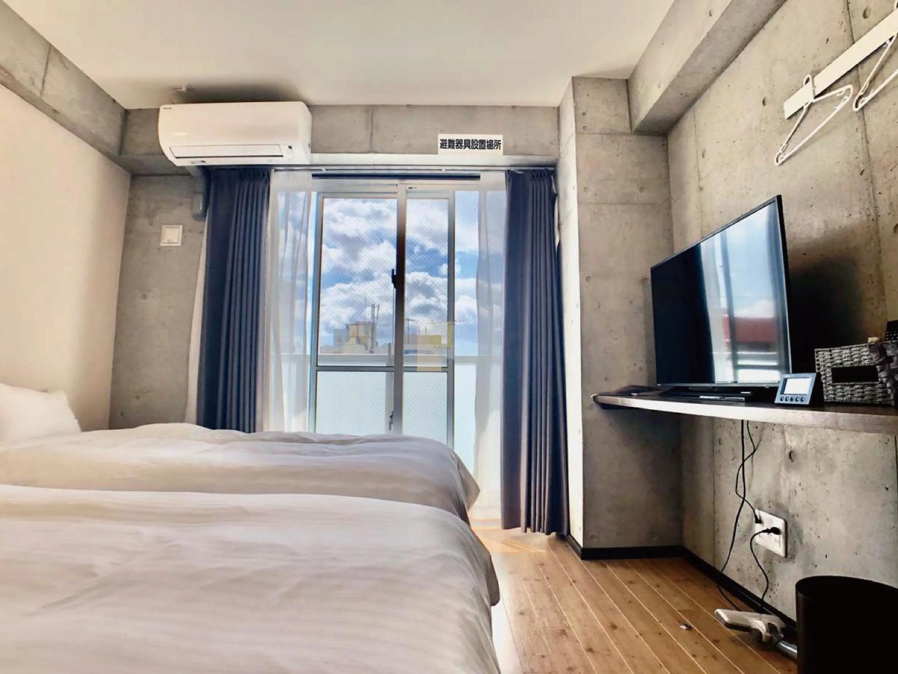 Bed in Infinity Hotel NahaKumoji -SEVEN Hotels and Resorts-