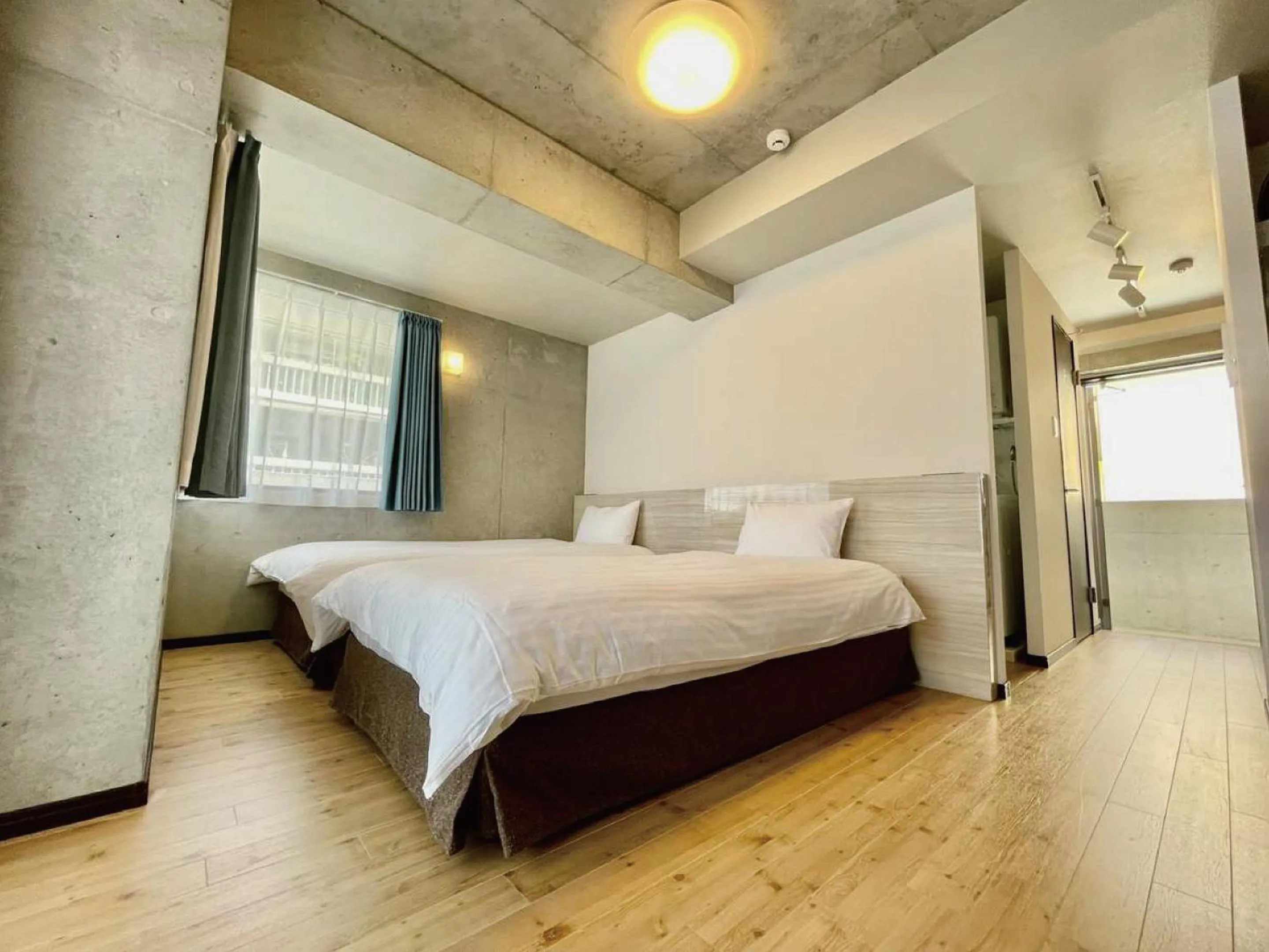 Bed in Infinity Hotel NahaKumoji -SEVEN Hotels and Resorts-