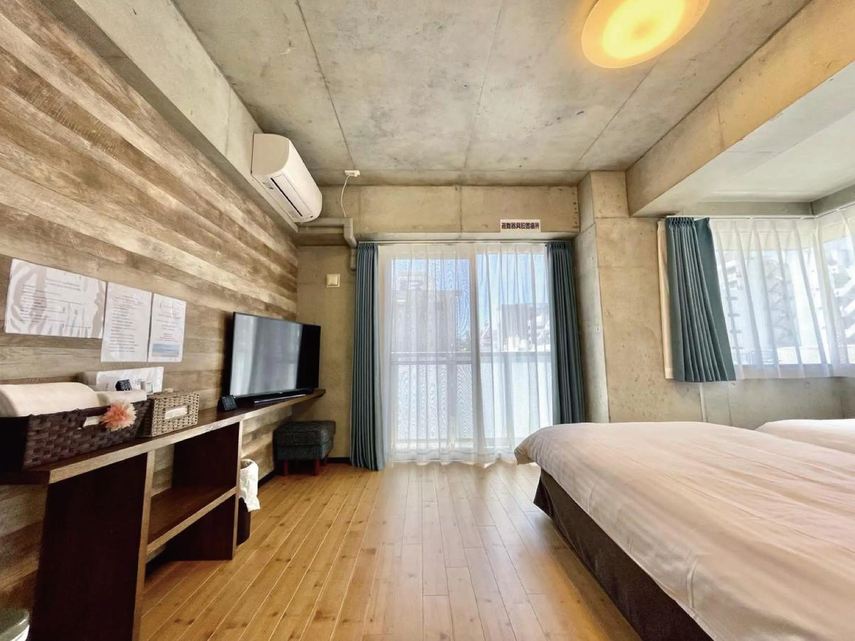 Bed in Infinity Hotel NahaKumoji -SEVEN Hotels and Resorts-