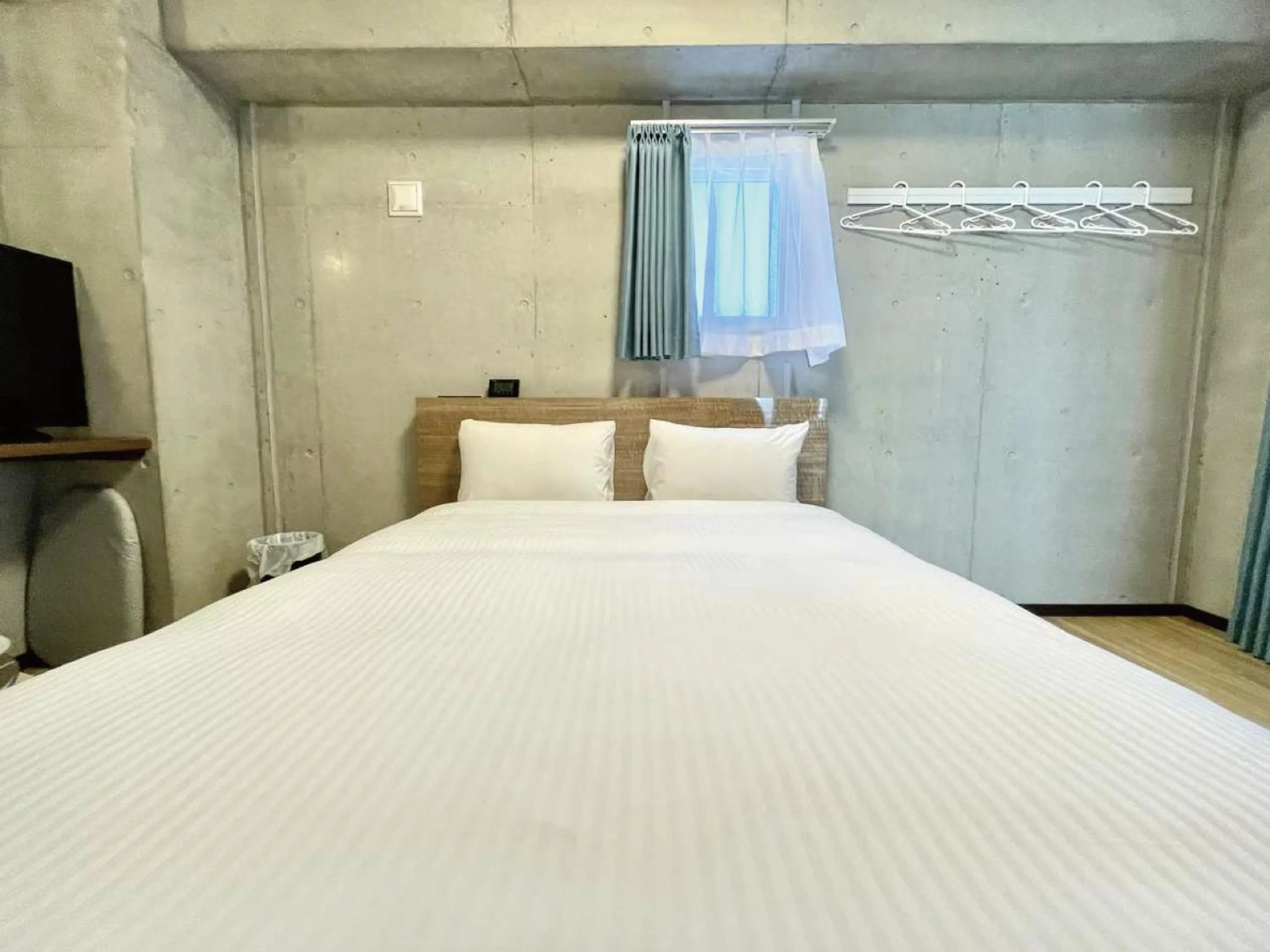 Bed in Infinity Hotel NahaKumoji -SEVEN Hotels and Resorts-