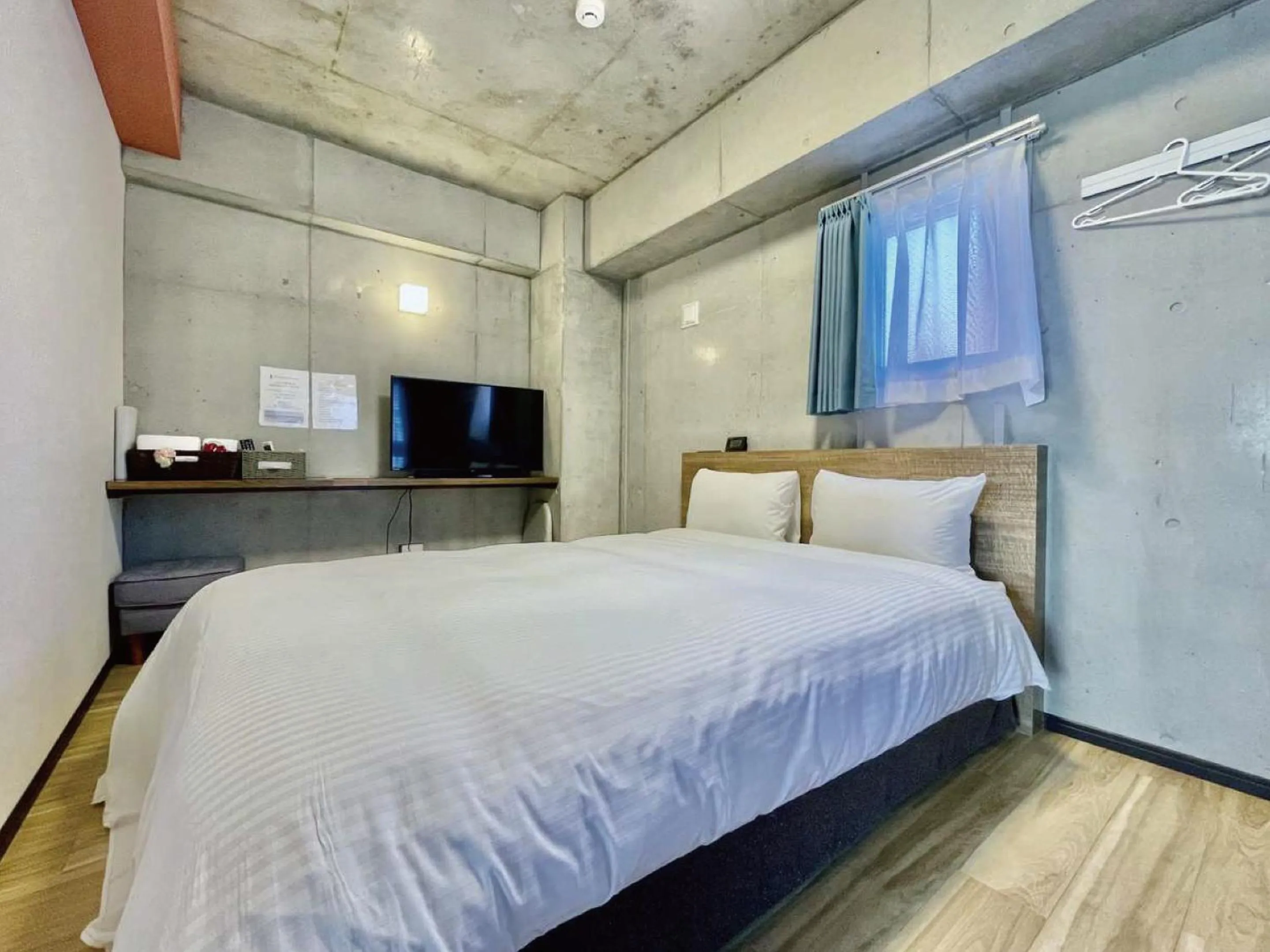 Bed in Infinity Hotel NahaKumoji -SEVEN Hotels and Resorts-