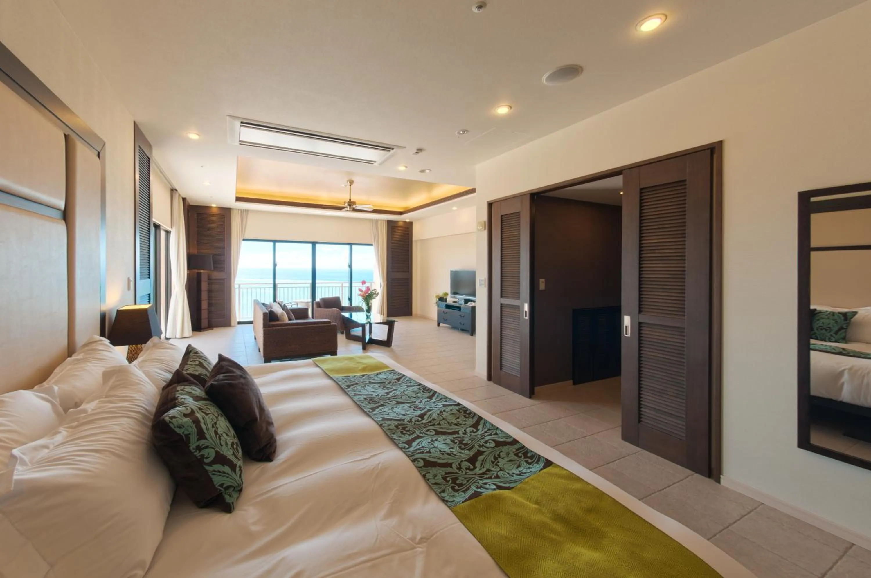 Bed in Kafuu Resort Fuchaku Condo Hotel